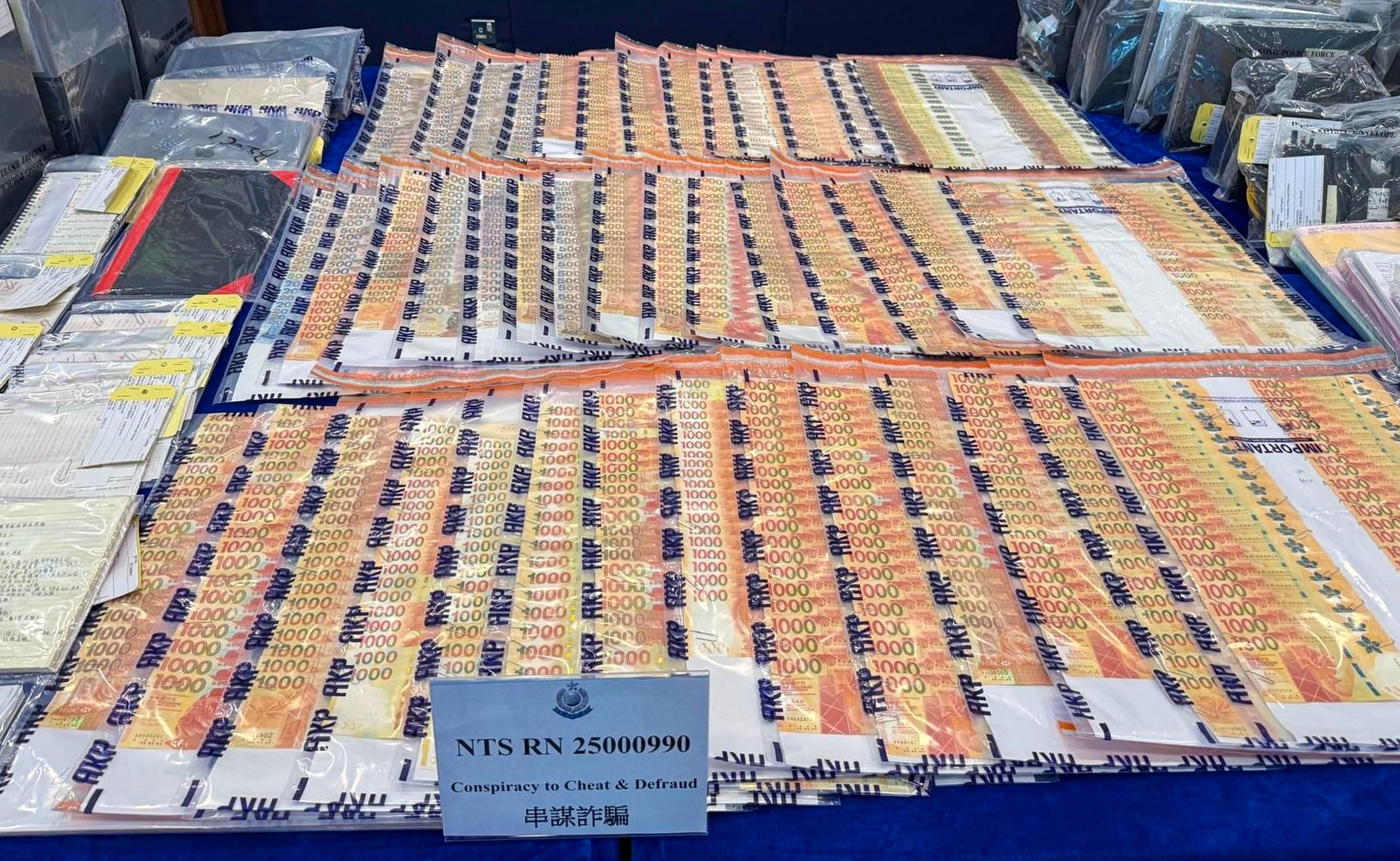Stacks of money are displayed as evidence in a scam case. There were 43,212 scam cases last year, according to police. Photo: Handout