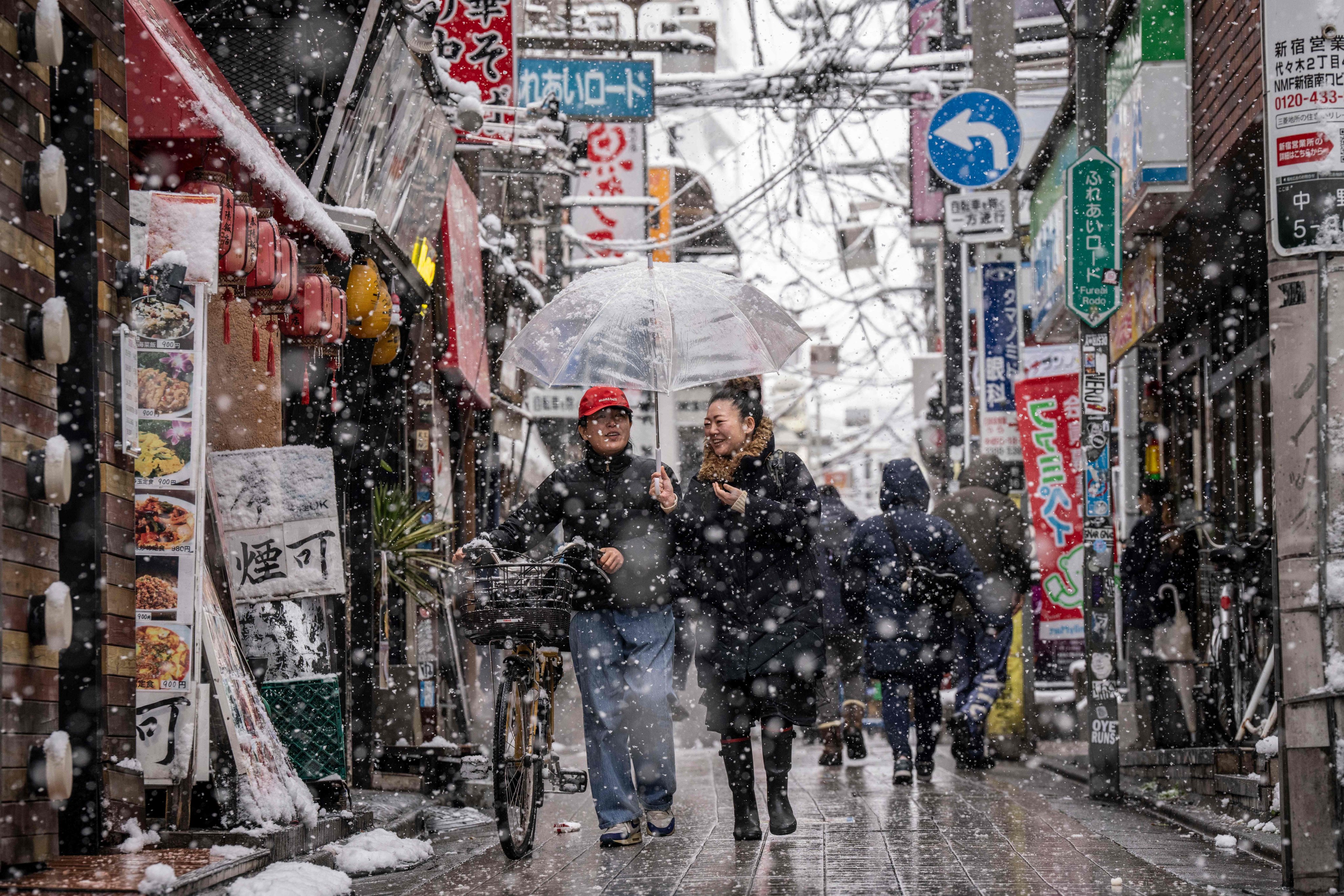 Shoppers walk through the Nakano area of Tokyo on Sunday. Inflation-adjusted wages have fallen for the past four years in Japan. Photo: AFP