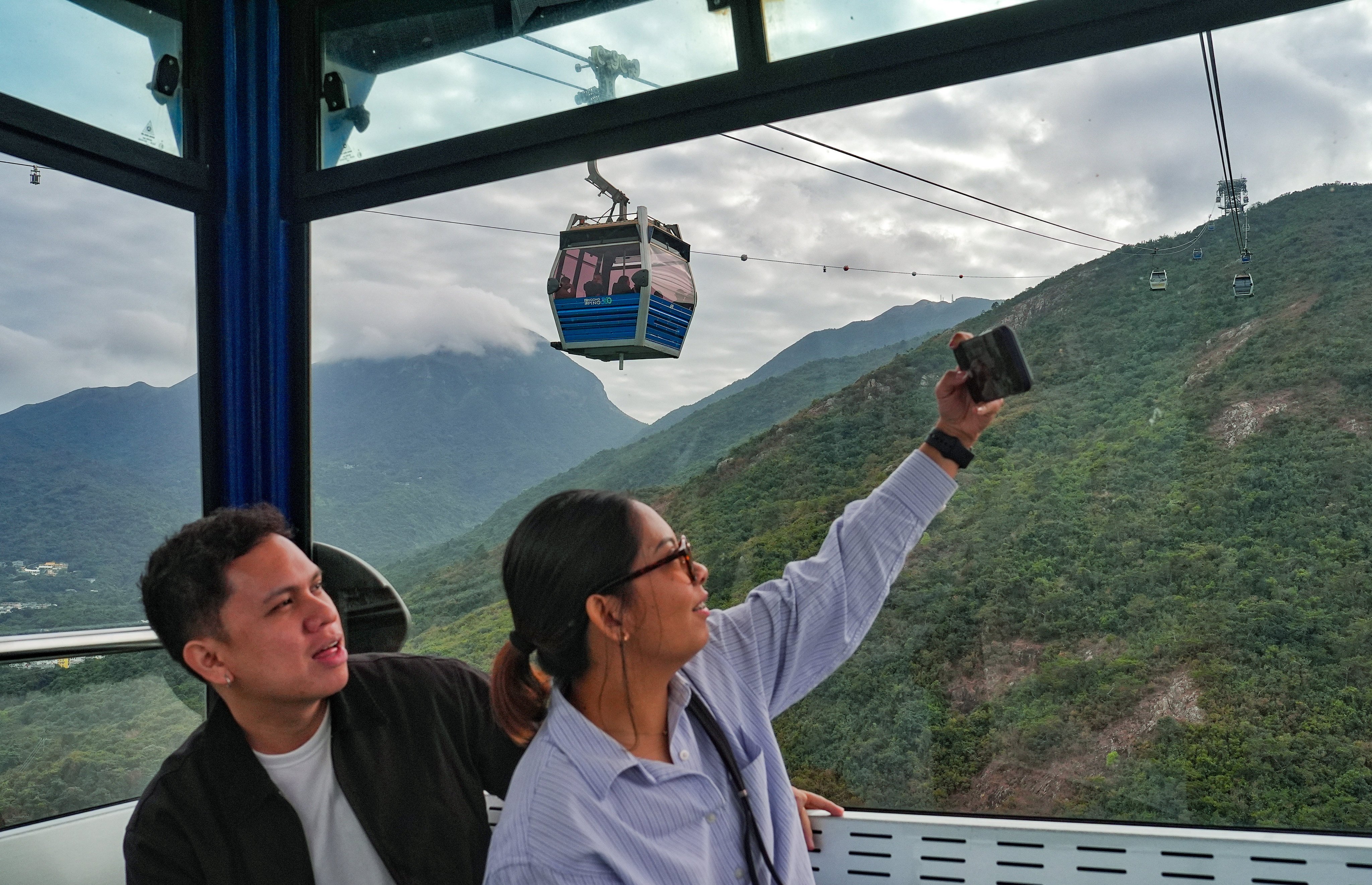 Passengers enjoy a ride on the Ngong Ping 360 cable car. Photo: Elson Li