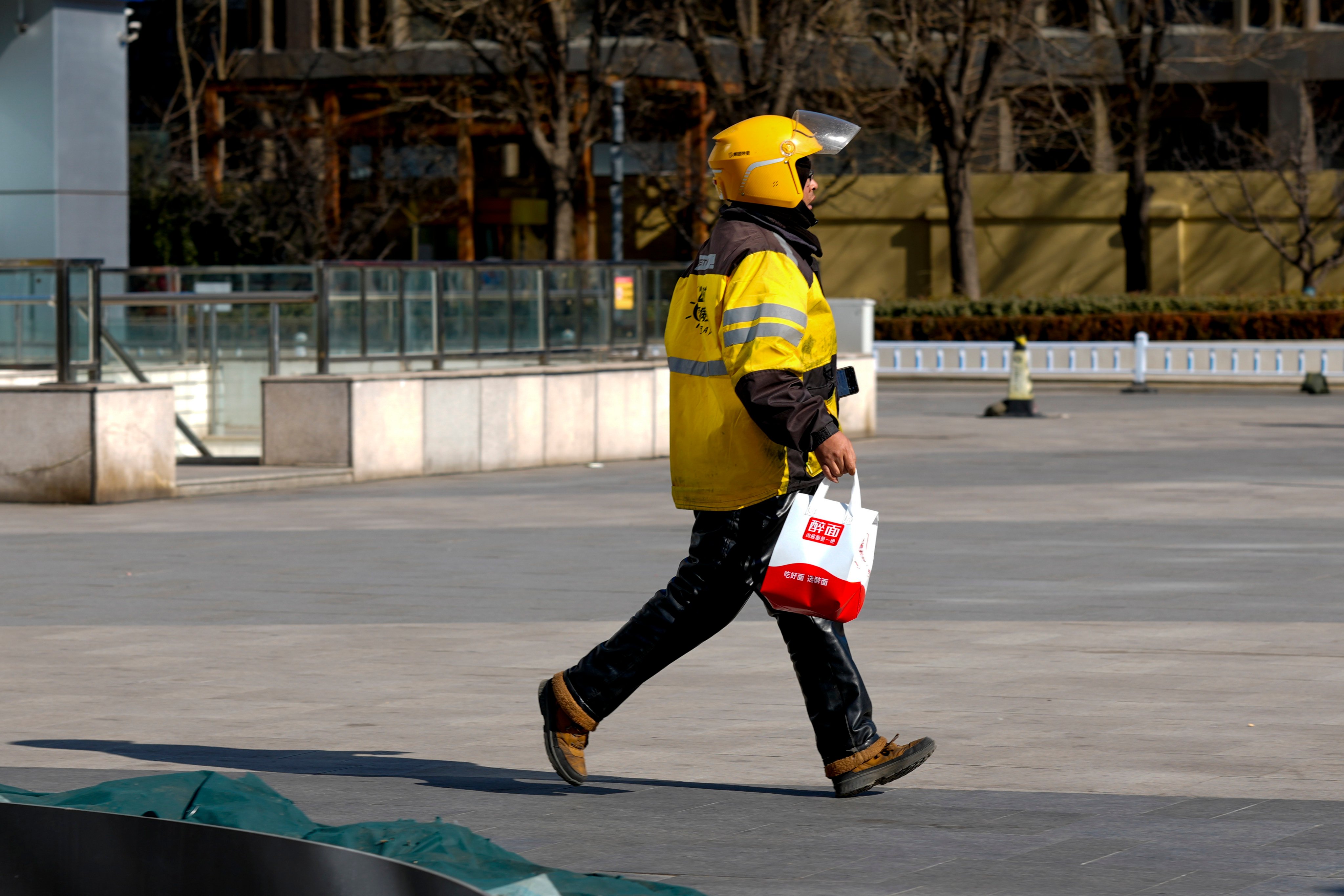 A delivery driver rushes with an order on February 8, 2026, in Beijing. Photo: Getty Images