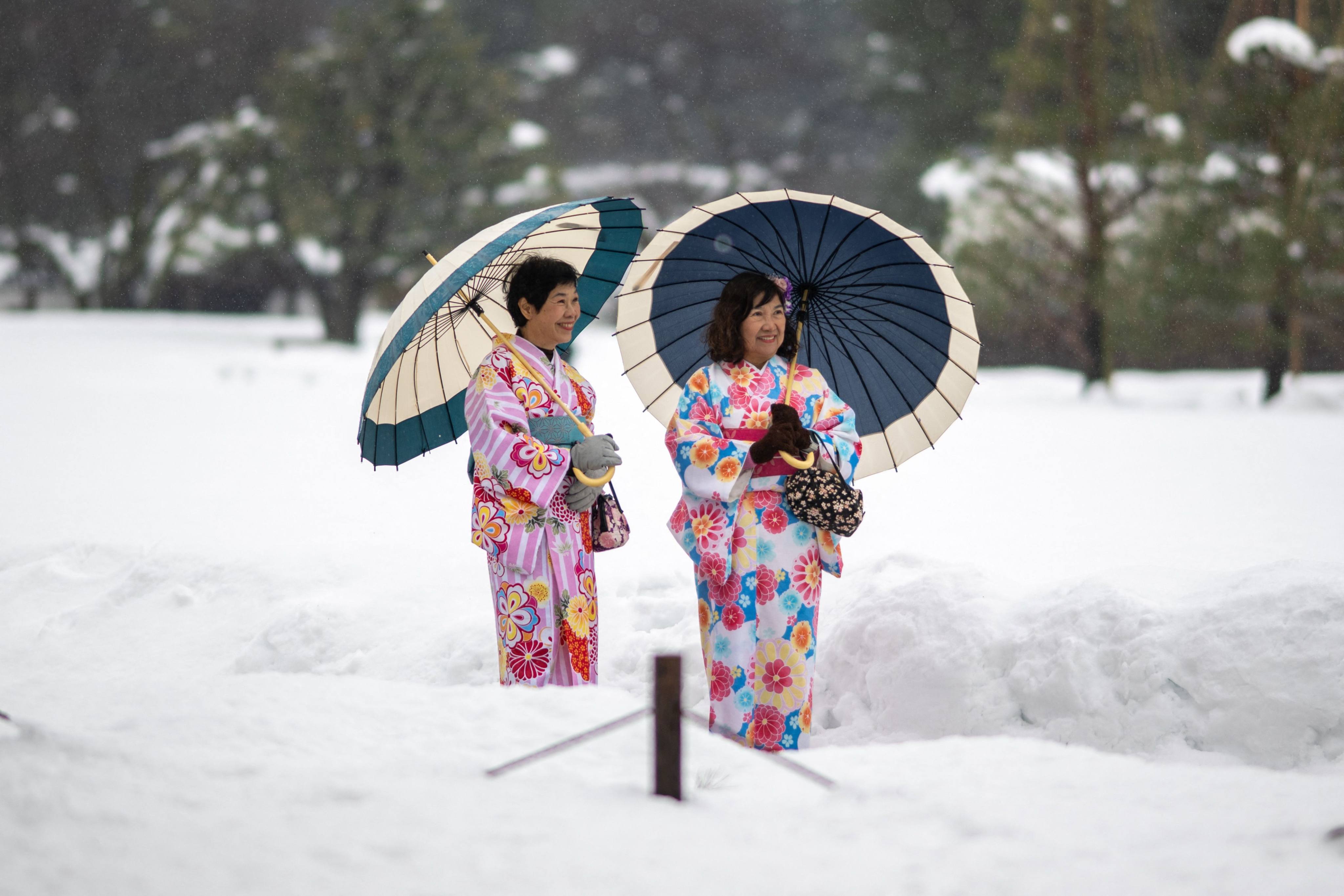 Tourists in traditional outfits visit the snow-covered Kanazawa Castle in Japan’s Ishikawa prefecture last month. Photo: AFP