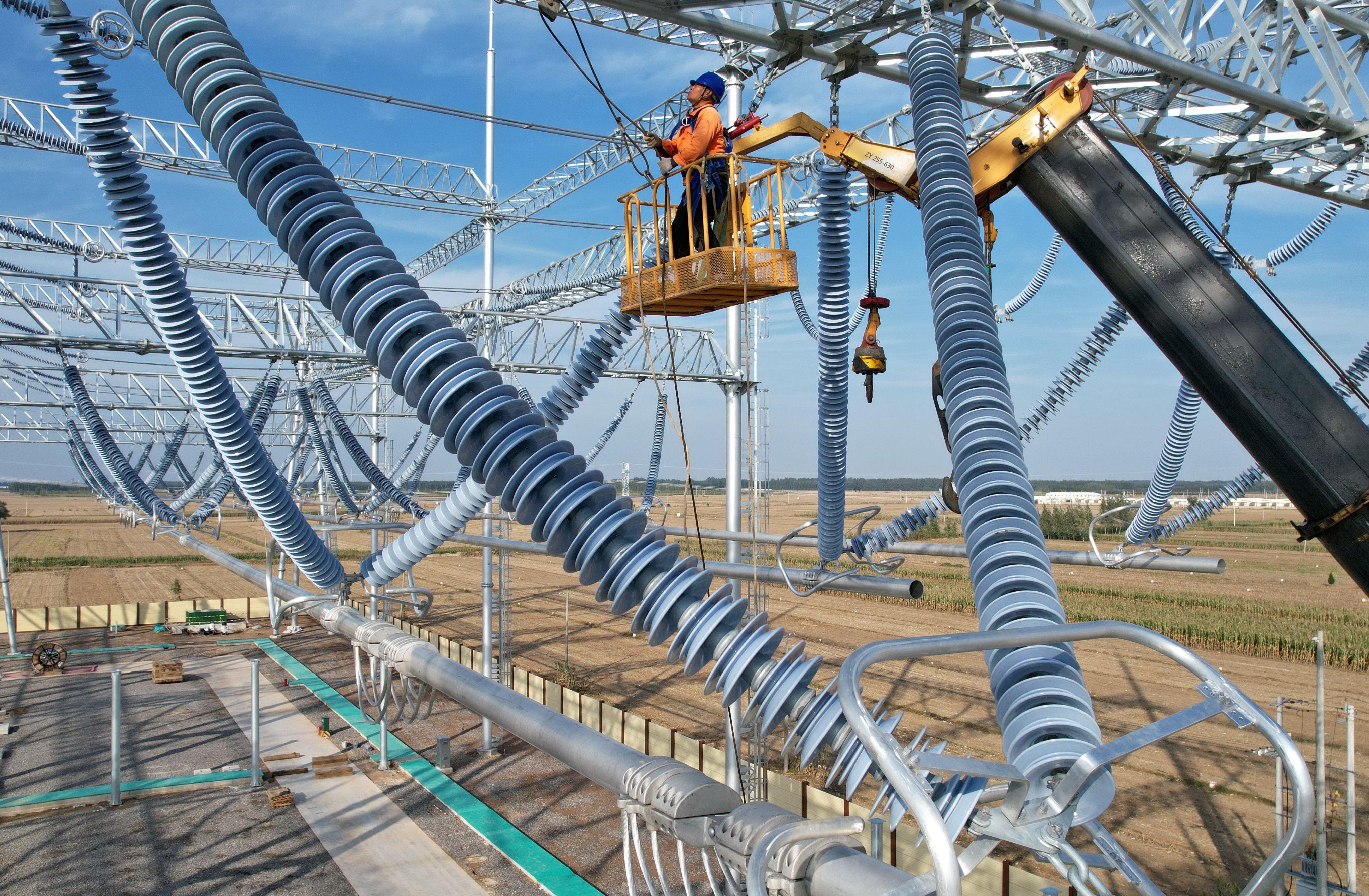 Workers are seen at a power substation in China’s Hebei province. Photo: Xinhua