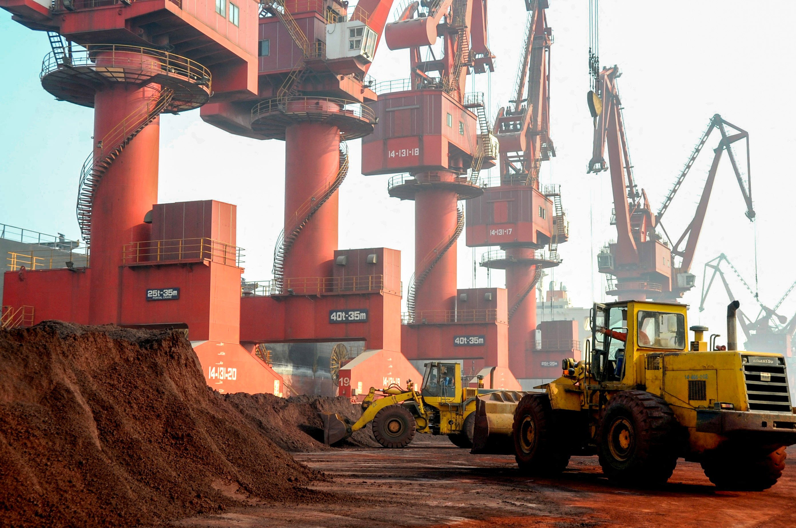 Workers transport soil containing rare earth elements for export at a port in China’s eastern Jiangsu province. Photo: Reuters