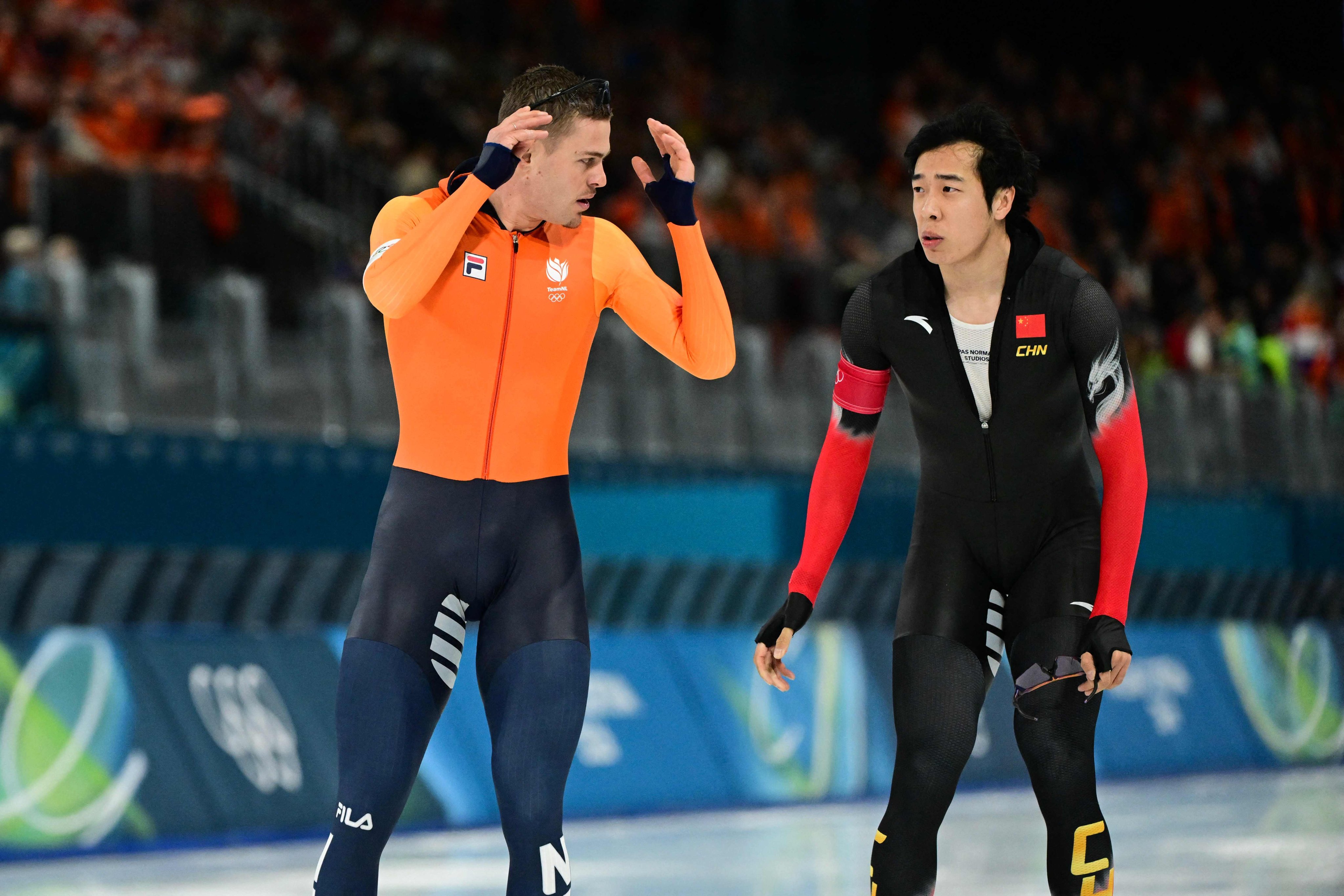 The Netherlands’ Joep Wennemars (left) and China’s Lian Ziwen after their pairs race in the speed skating 1000m event at the Milano Cortina Games on Wednesday. Photo: AFP