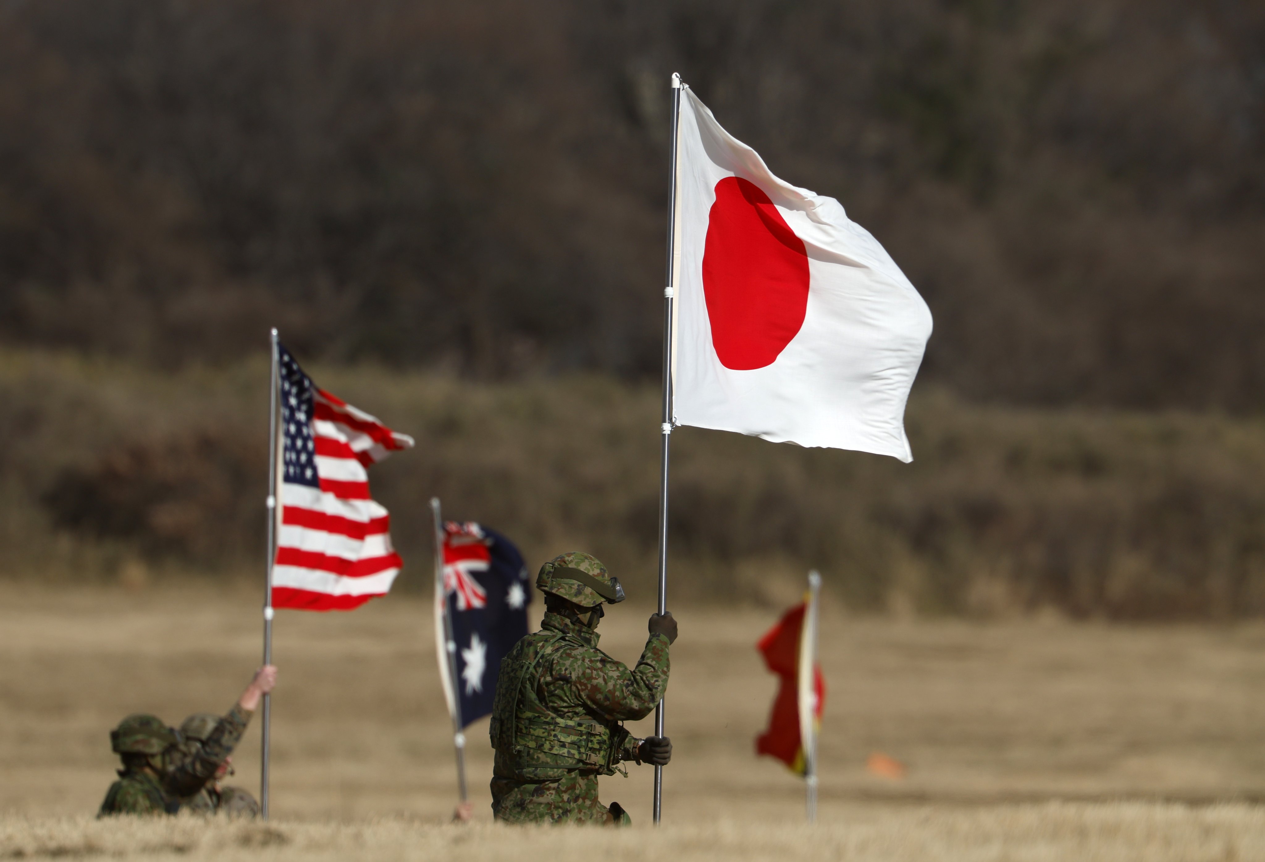 Military personnel hold national flags of Japan and the US during a Japan Ground Self-Defence Force training at Camp Narashino, near Tokyo, on January 11. Photo: EPA
