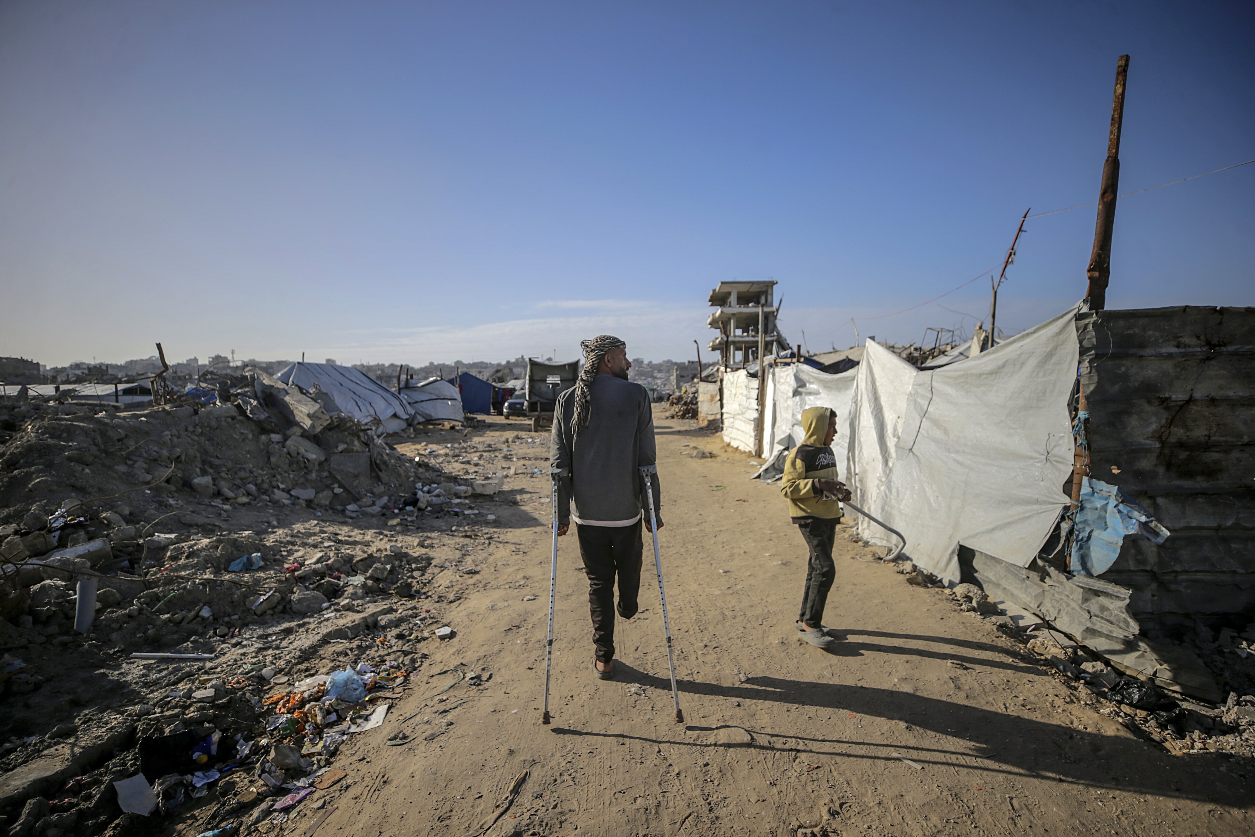 Internally displaced Palestinians walk among the ruins of the Al Tuffah neighbourhood in eastern Gaza City on February 11. The UN human rights office has maintained a presence in Gaza despite the challenges. Photo: EPA