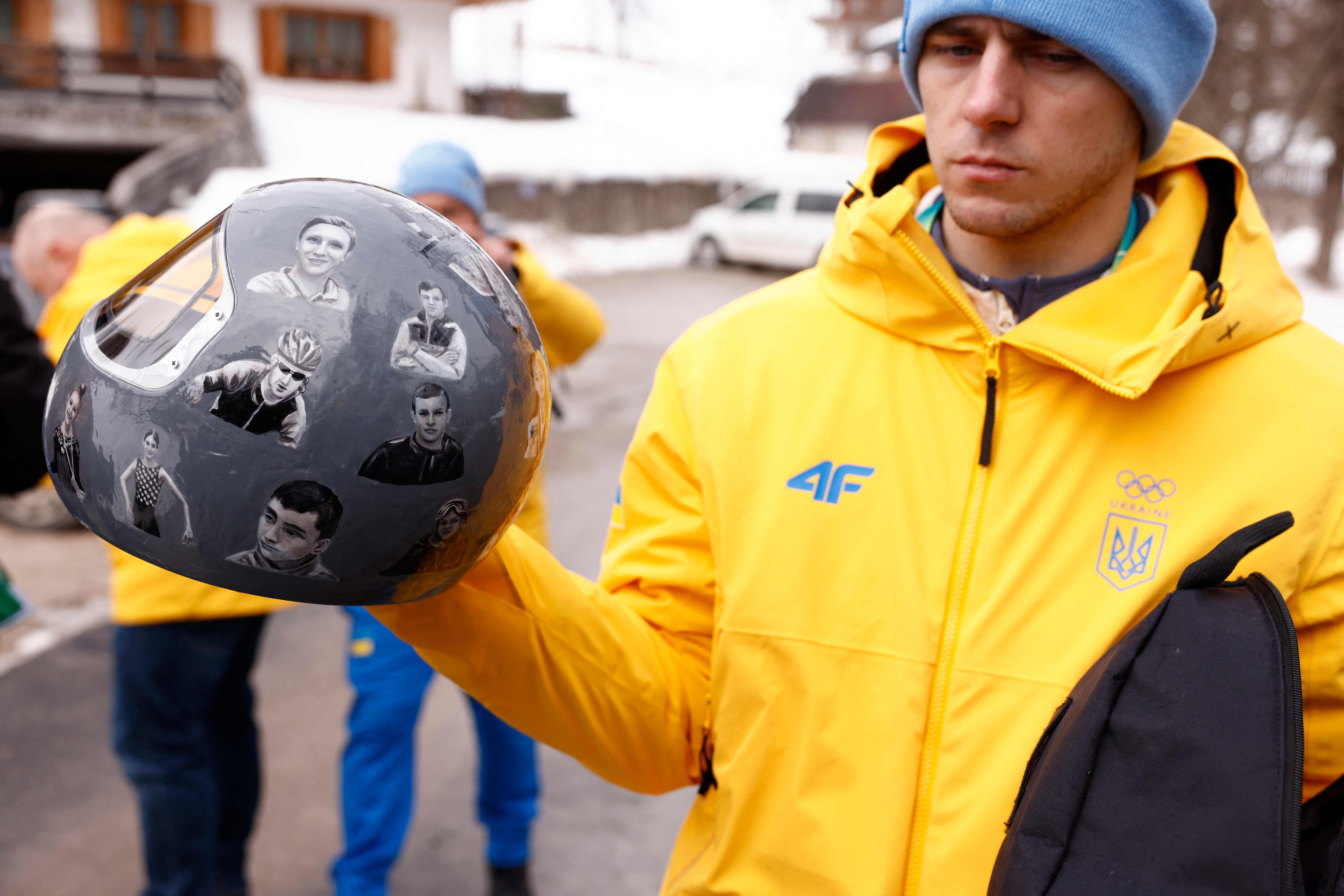 Ukraine skeleton racer Vladyslav Heraskevych holds his helmet, which depicts sporting victims of his country’s war with Russia. Photo: AFP