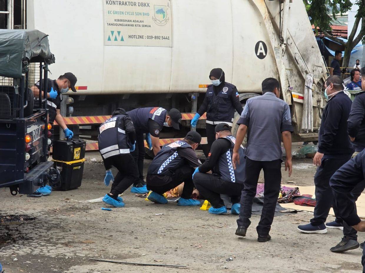Malaysian police officers investigate a crime scene in Indah Permai, Kota Kinabalu. Photo: The Star