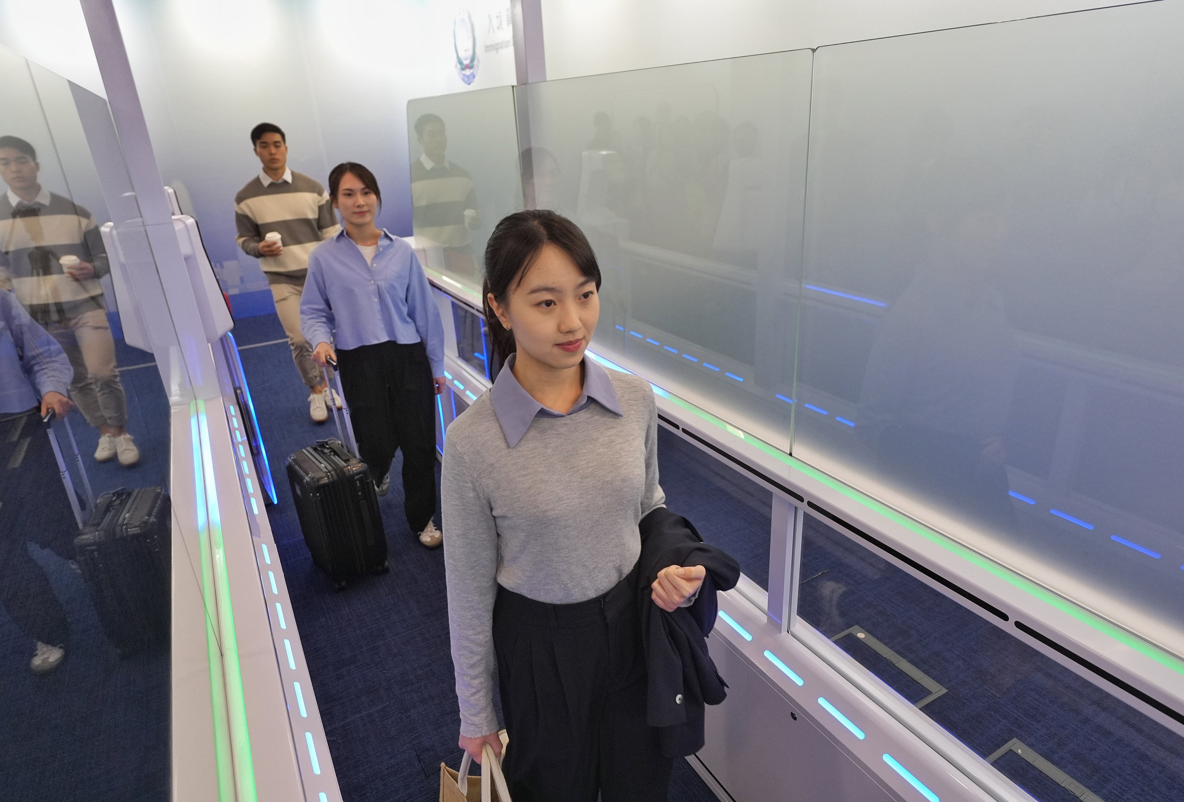 Participants demonstrate crossing the new e-channel system. Photo: Elson Li