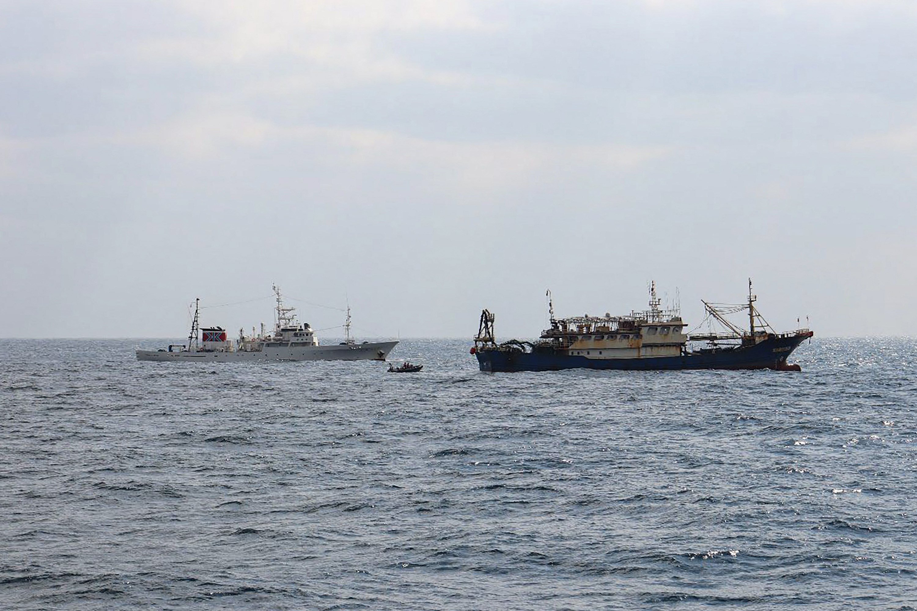 Japan’s Fisheries Agency says this photo taken on February 12 shows a patrol vessel, Hakuo Maru (left), and a Chinese fishing vessel sailing within Japan’s exclusive economic zone off Nagasaki prefecture. Photo: AFP