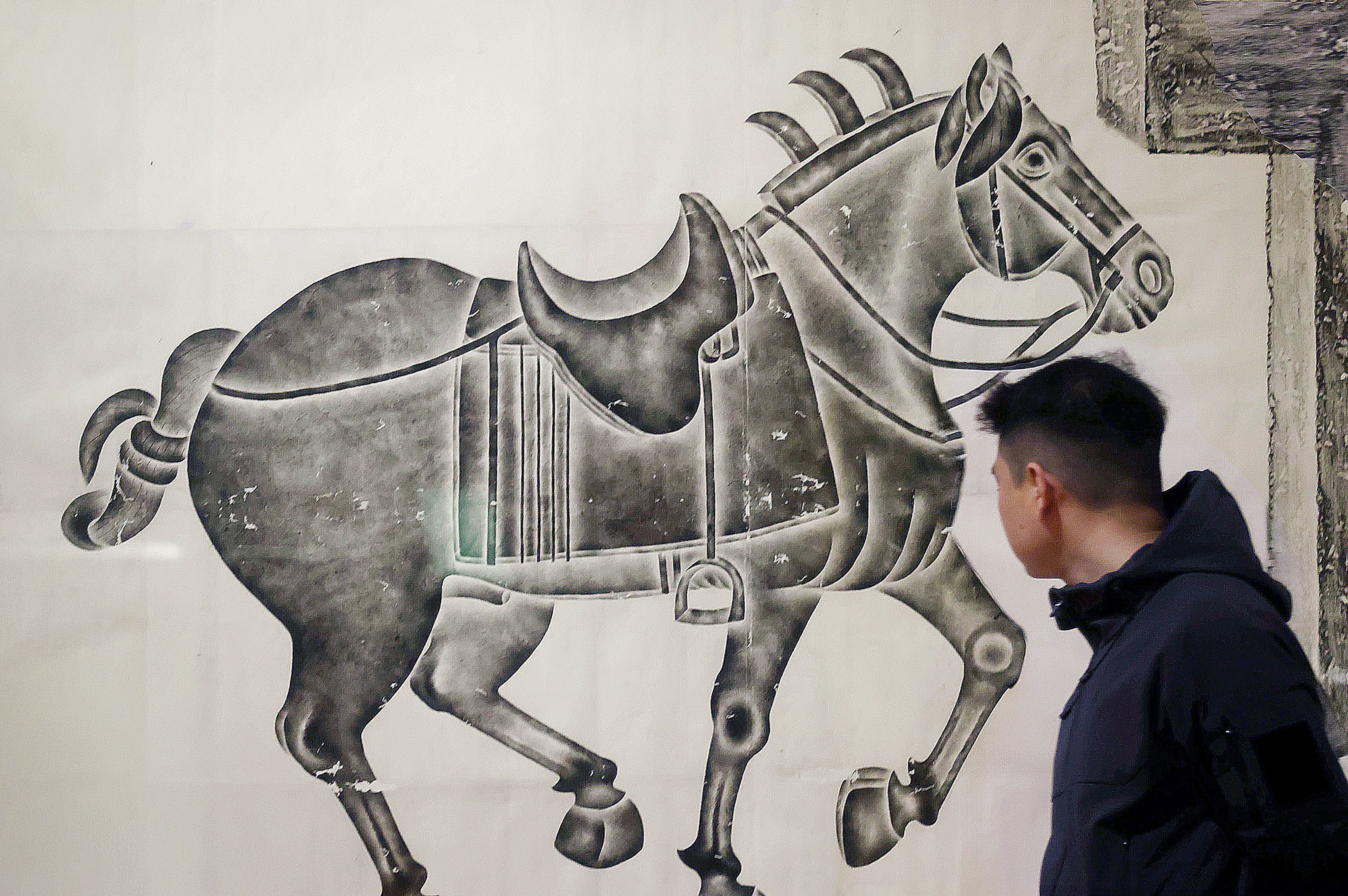 A patron passes the “Celebrating the Year of the Horse” exhibition at The Art Museum at The Chinese University of Hong Kong, on January 23. Photo: Jonathan Wong