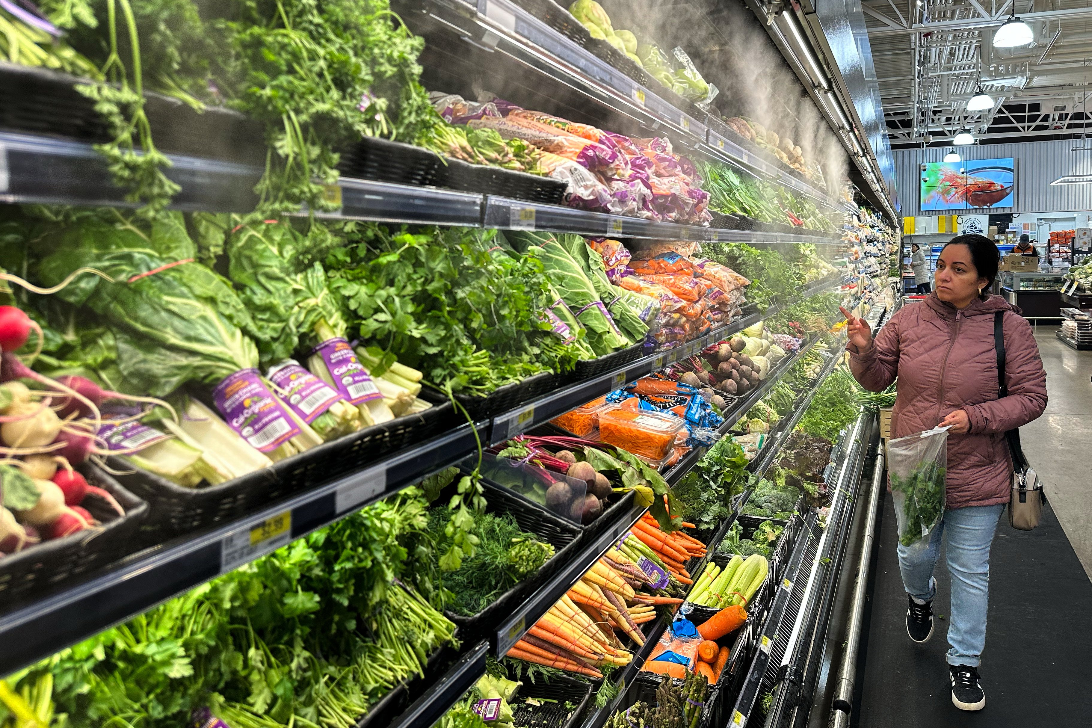 A shopper looks at vegetables in a grocery store in Schaumburg, Illinois, on Monday. Photo: AP