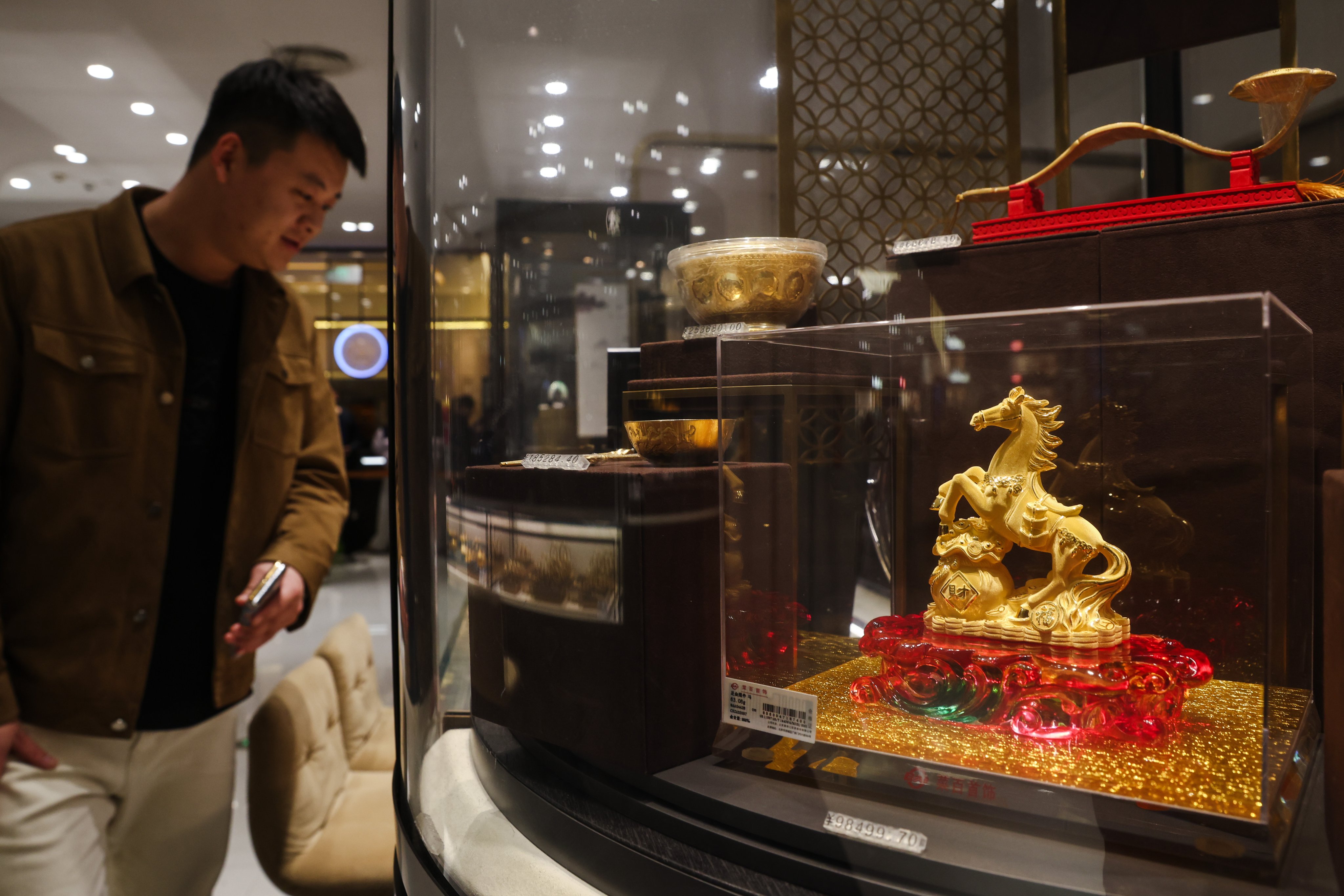 Decorative items made of gold are displayed at a jewellery store in Beijing on January 28. Photo: EPA-EFE