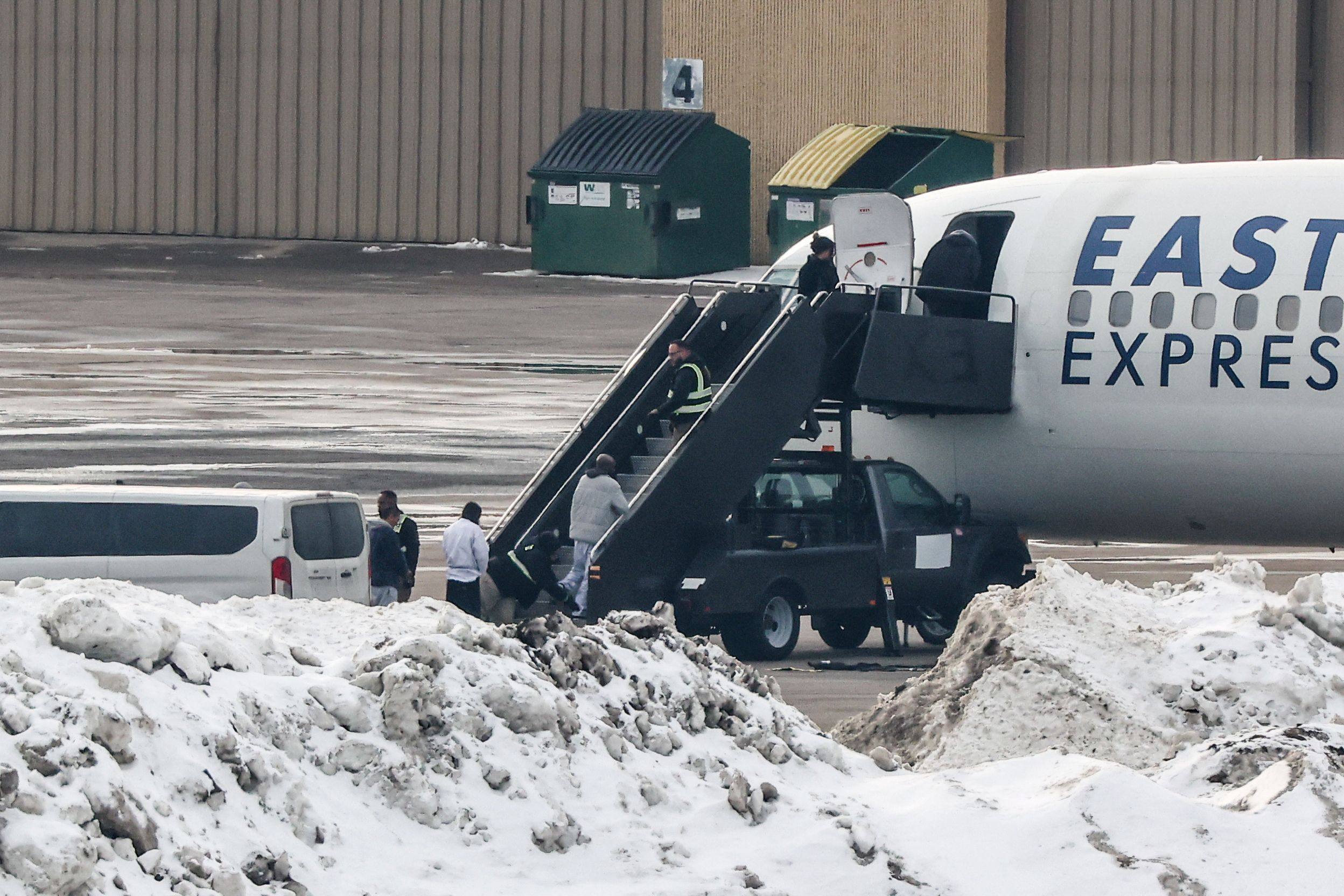 Shackled deportees board a plane at the Minneapolis-Saint Paul International Airport on February 5. Photo: AFP