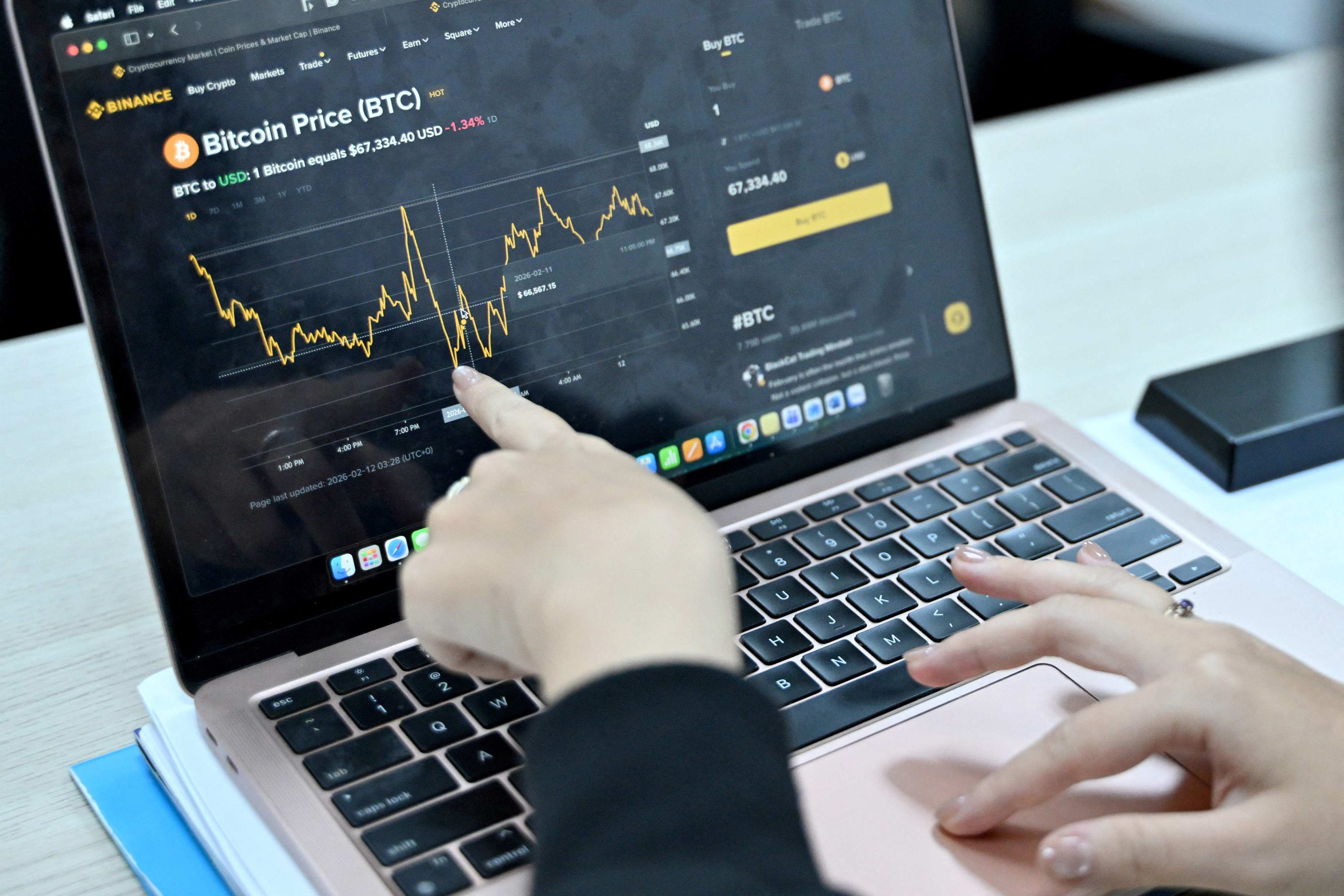 A Vietnamese cryptocurrency investor looks at the latest bitcoin values on a laptop in Hanoi. Photo: AFP