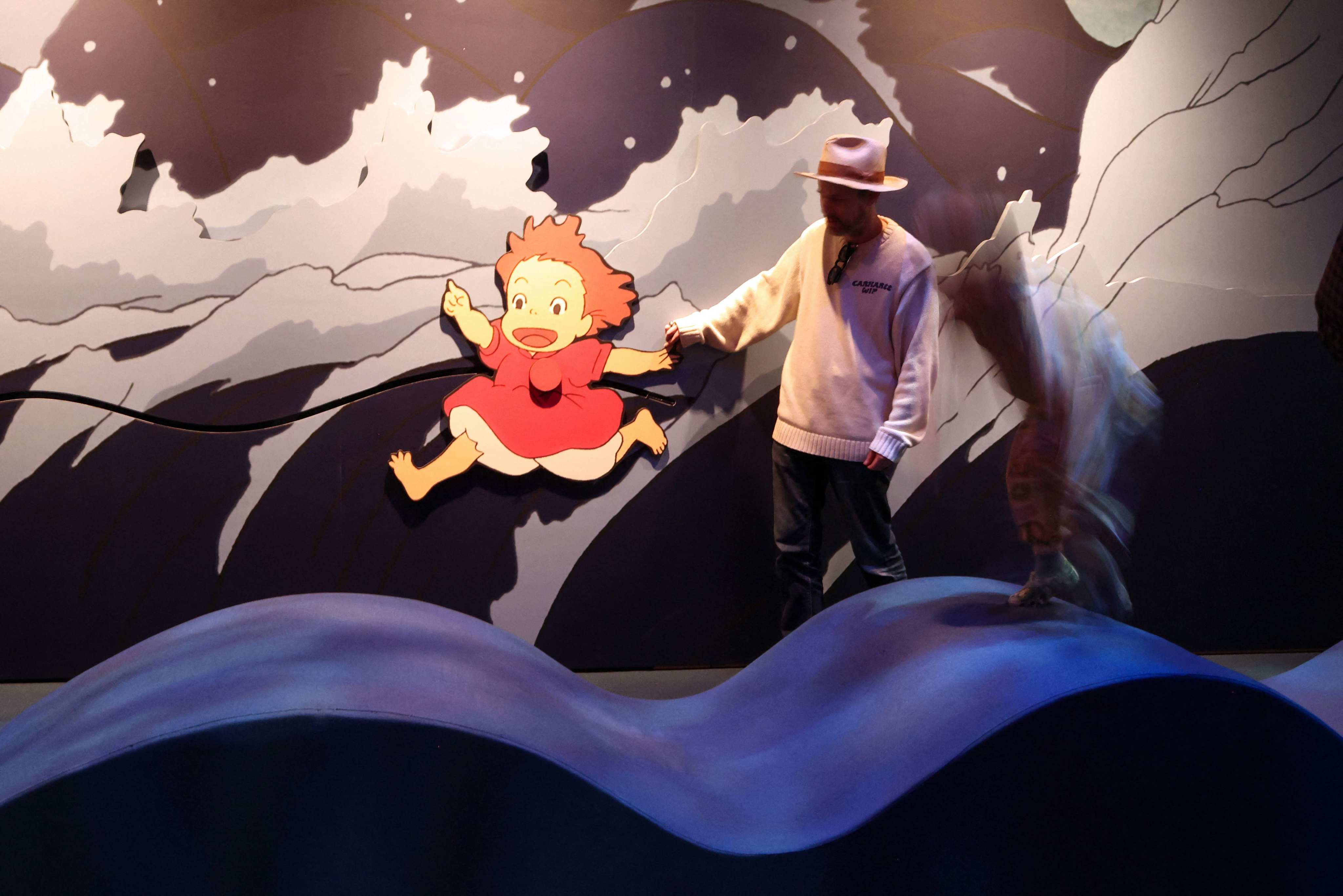 A visitor interacts with a Ponyo exhibit at “Studio Ghibli’s Ponyo”, a new exhibition at the Academy Museum of Motion Pictures in Los Angeles, on February 12, 2026. Photo: AFP