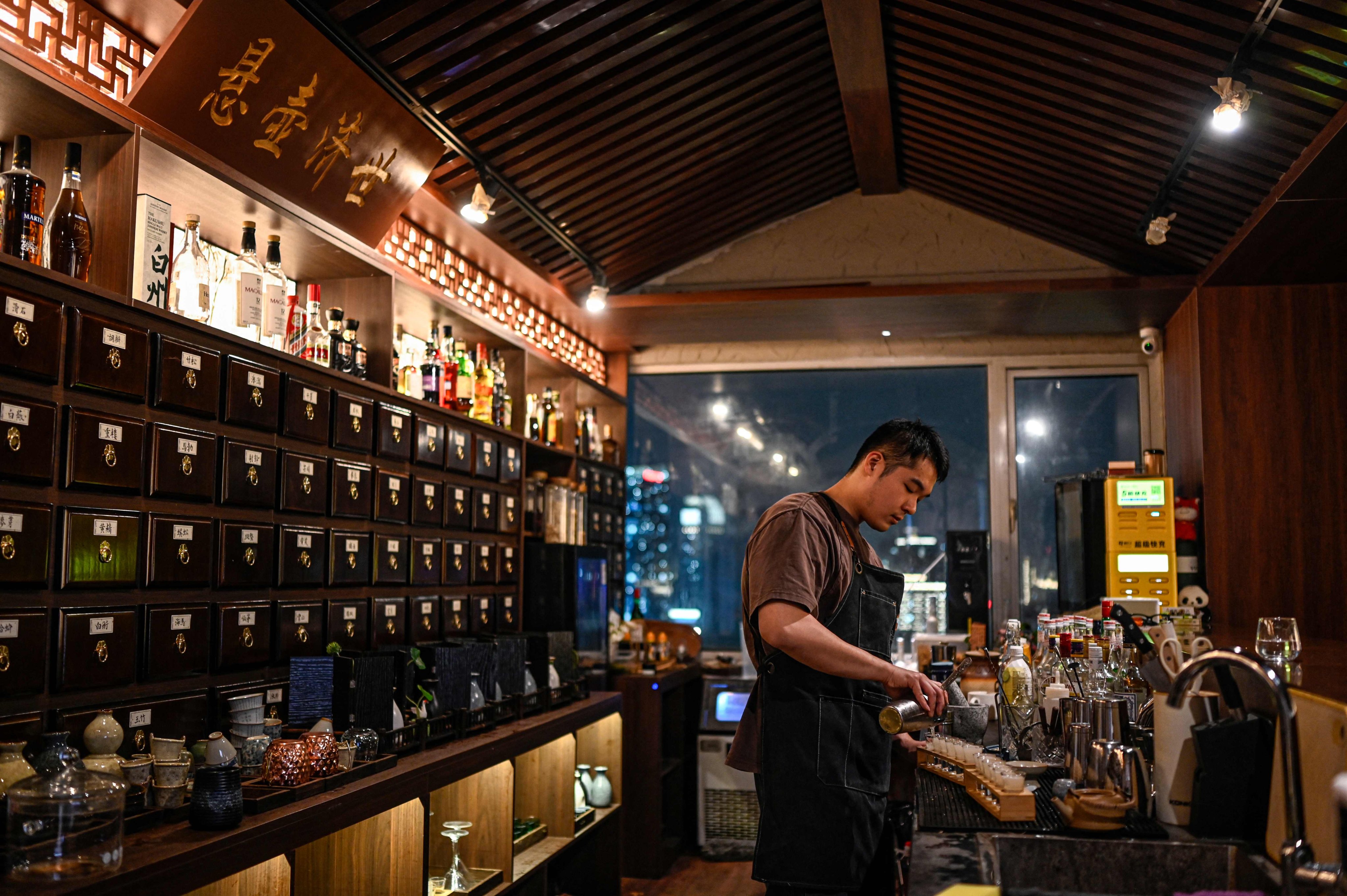 A bartender prepares shots at Niang Qing, a “TCM bar” in Shanghai, China. Similar bars based on traditional Chinese medicine have popped up in cities across China, epitomising what the country’s stressed-out, time-poor youth refer to as “punk wellness”, or “wrecking yourself while saving yourself”. Photo: AFP