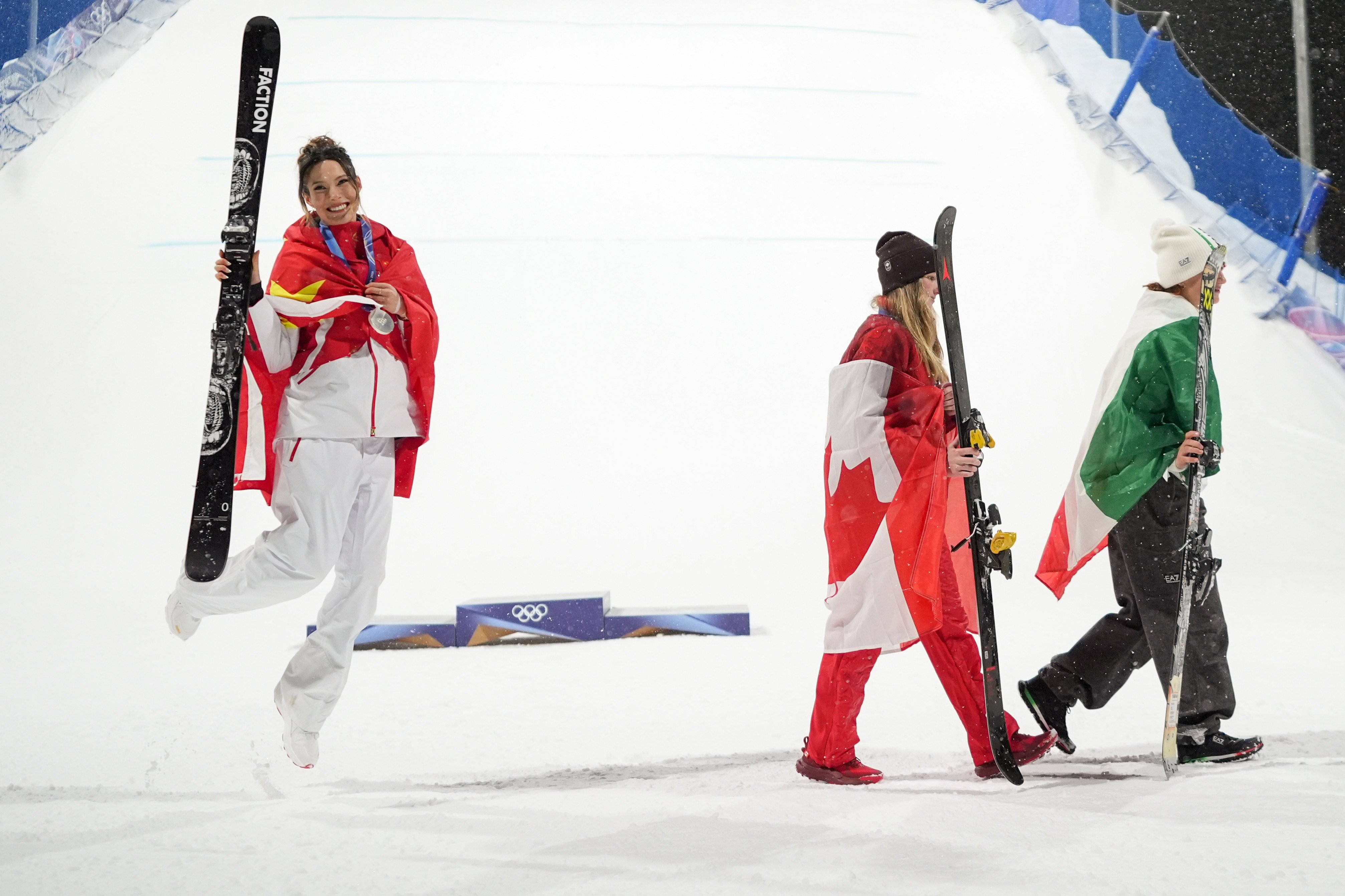China’s Eileen Gu (left) celebrates her silver as gold medalist Megan Oldham and bronze medalist Flora Tabanelli walk away. Photo: AP