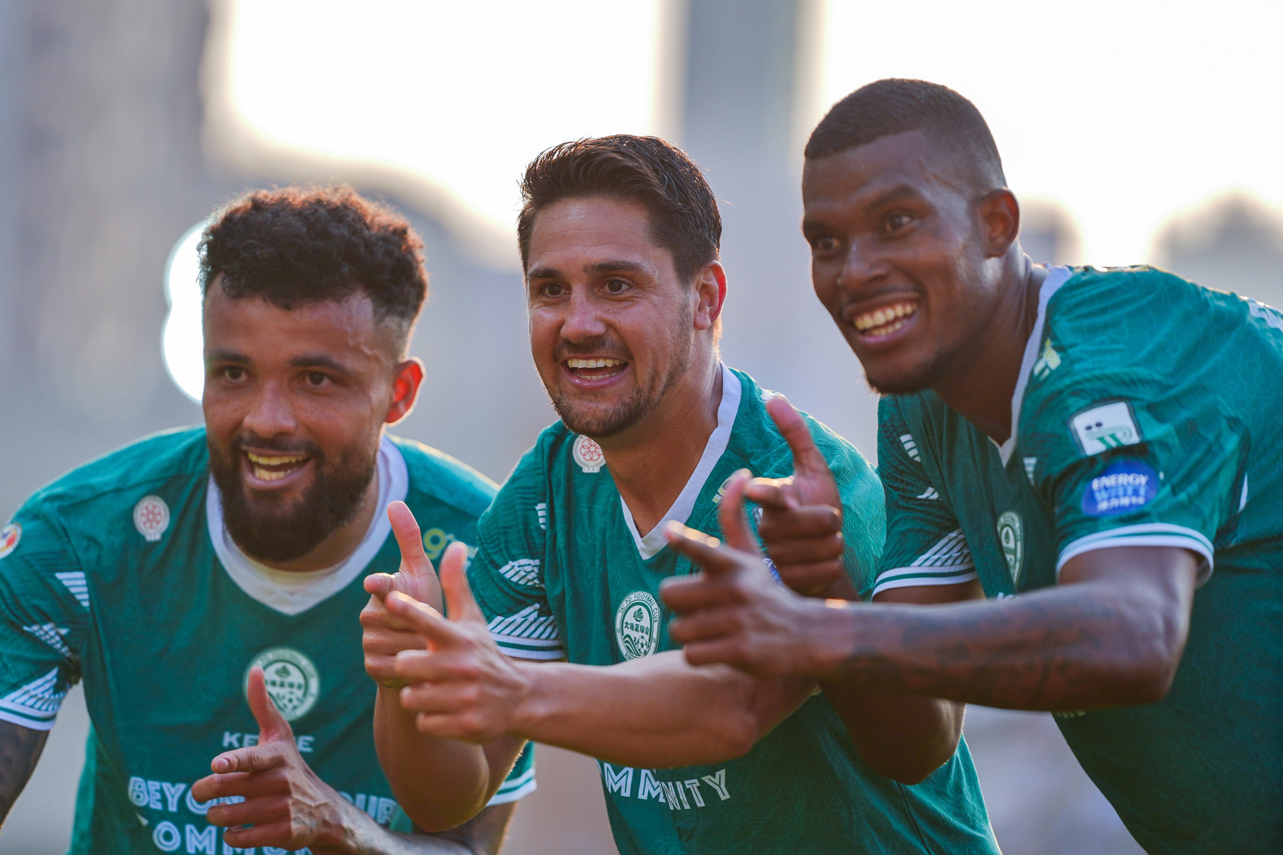 Paulinho Simionato (centre) celebrates his goal with Marcao (left) and Michel Renner. Photo: Elson Li
