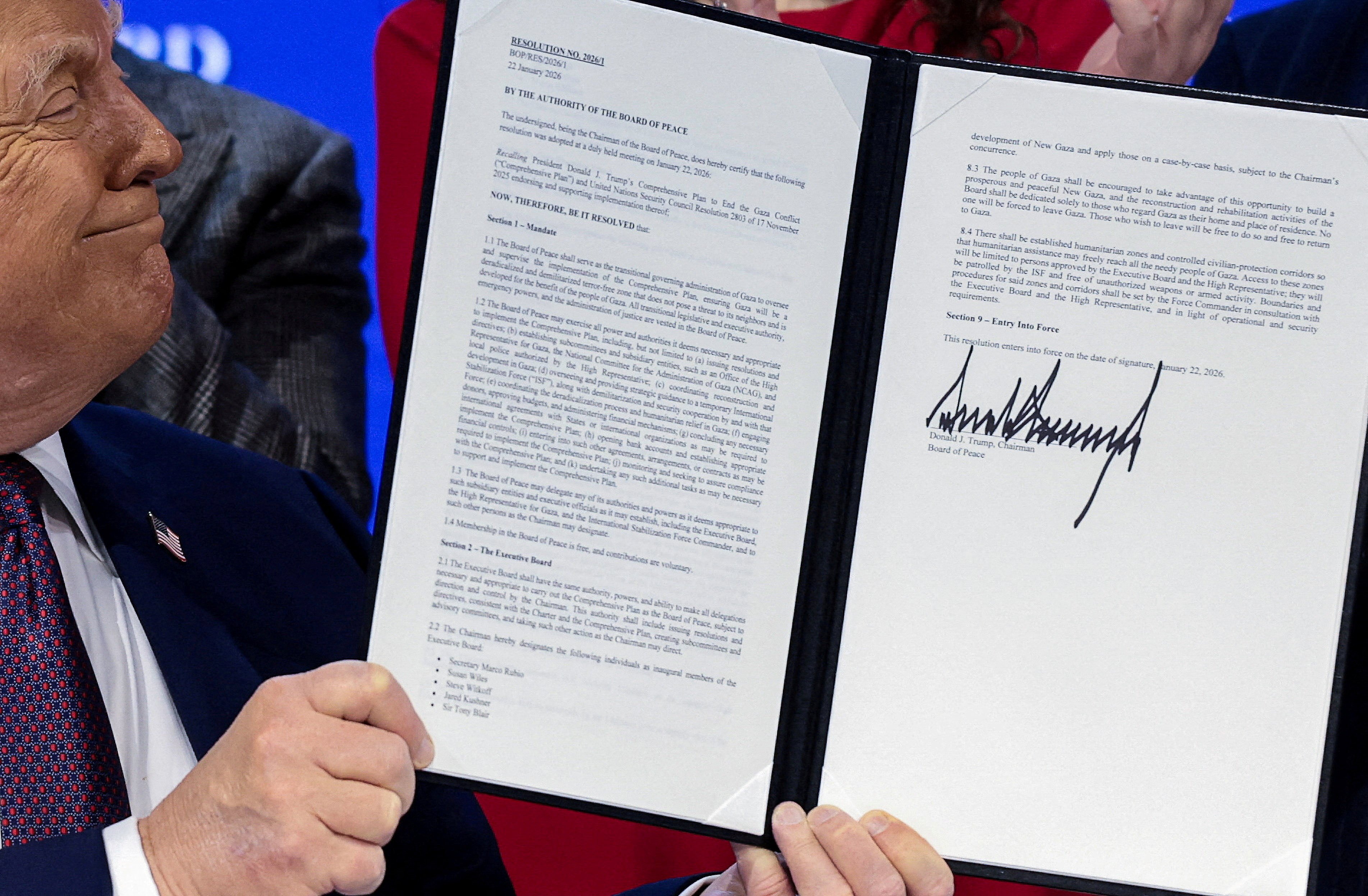 US President Donald Trump holds a signed resolution at the “Board of Peace” charter announcement in Davos on January 22. Photo: Reuters