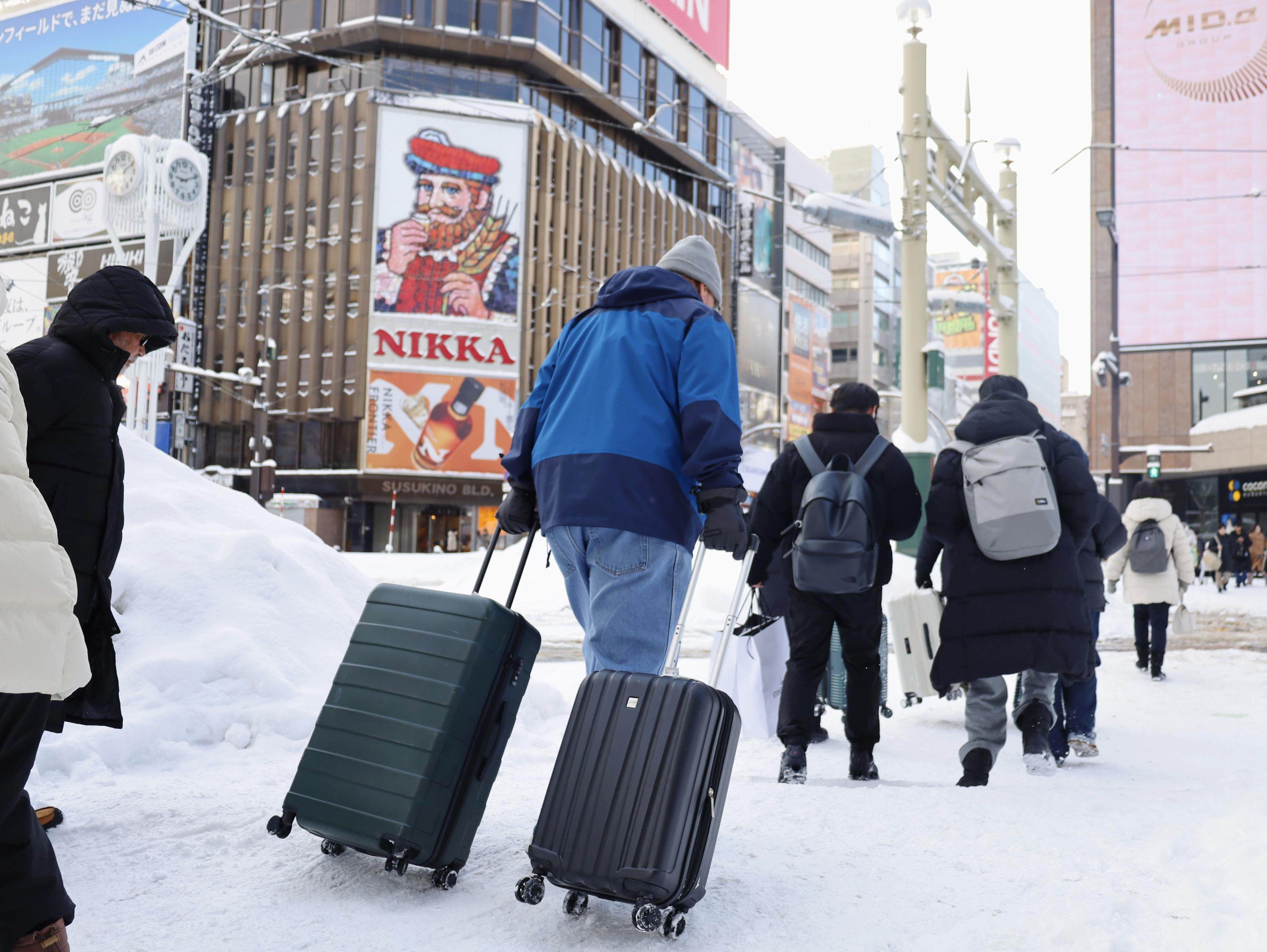 Travellers cross the road in Sapporo. Photo: Kyodo