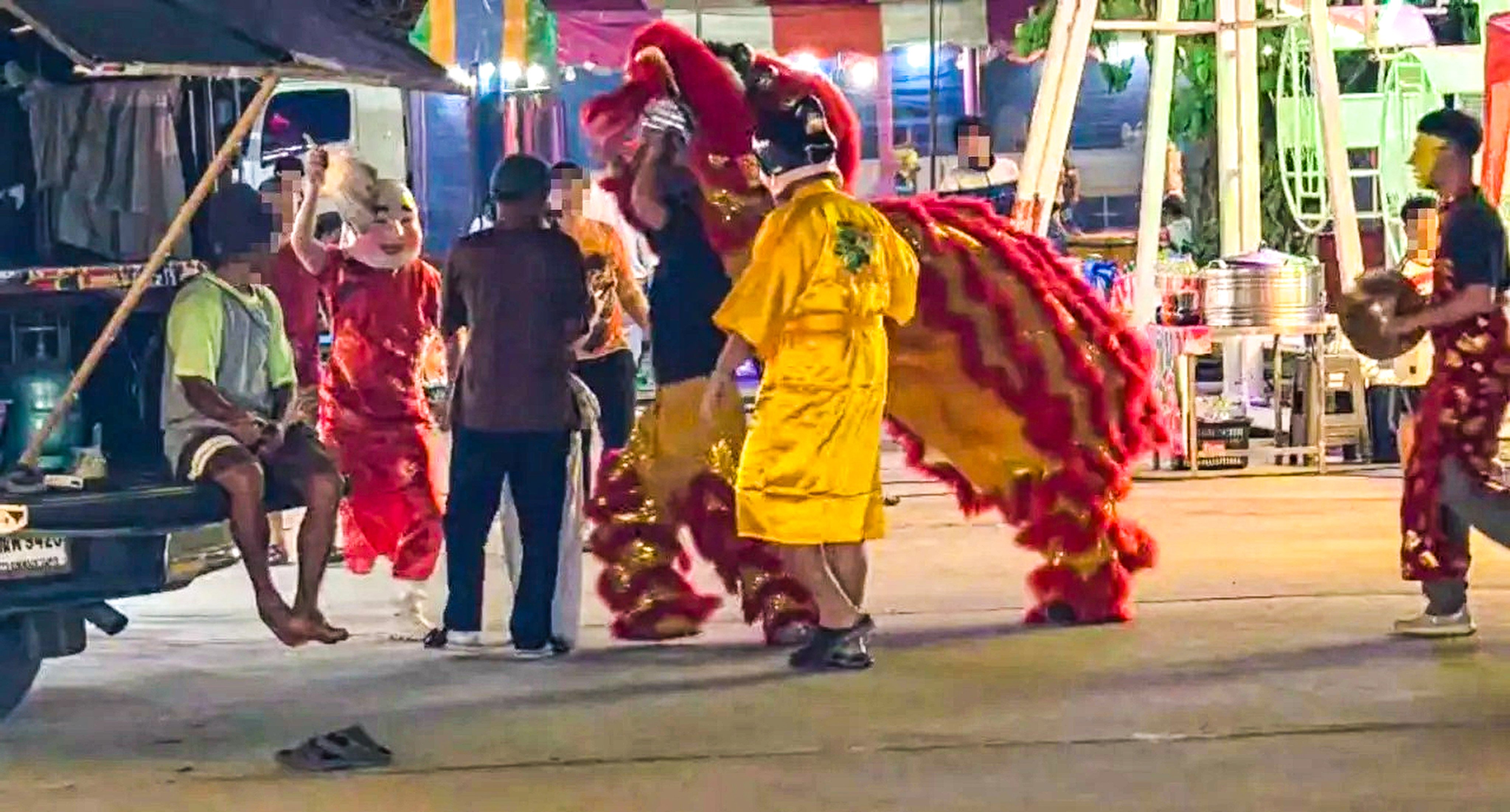 Disguised as a lion dance troupe, Thai police home in on the man in a brown T-shirt. Photo:  Handout