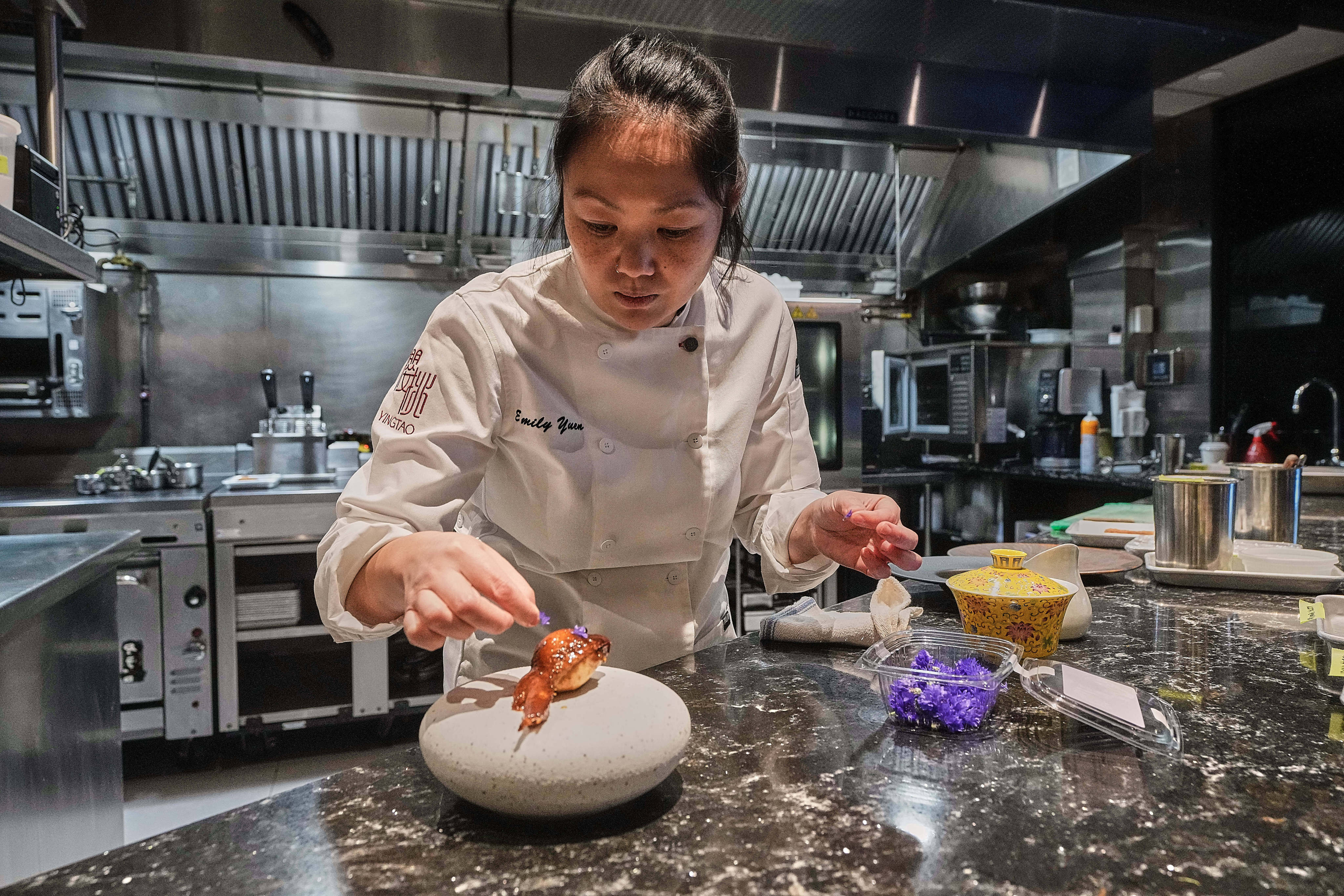 Emily Yuen, chef at one-Michelin-star Chinese restaurant Yingtao in New York’s Hell’s Kitchen, prepares lo mai gai - sticky rice, lap cheong and salted duck egg yolk stuffed in a deboned chicken wing. Many chefs in the US are elevating Chinese cuisine and challenging stereotypes. Photo: AP