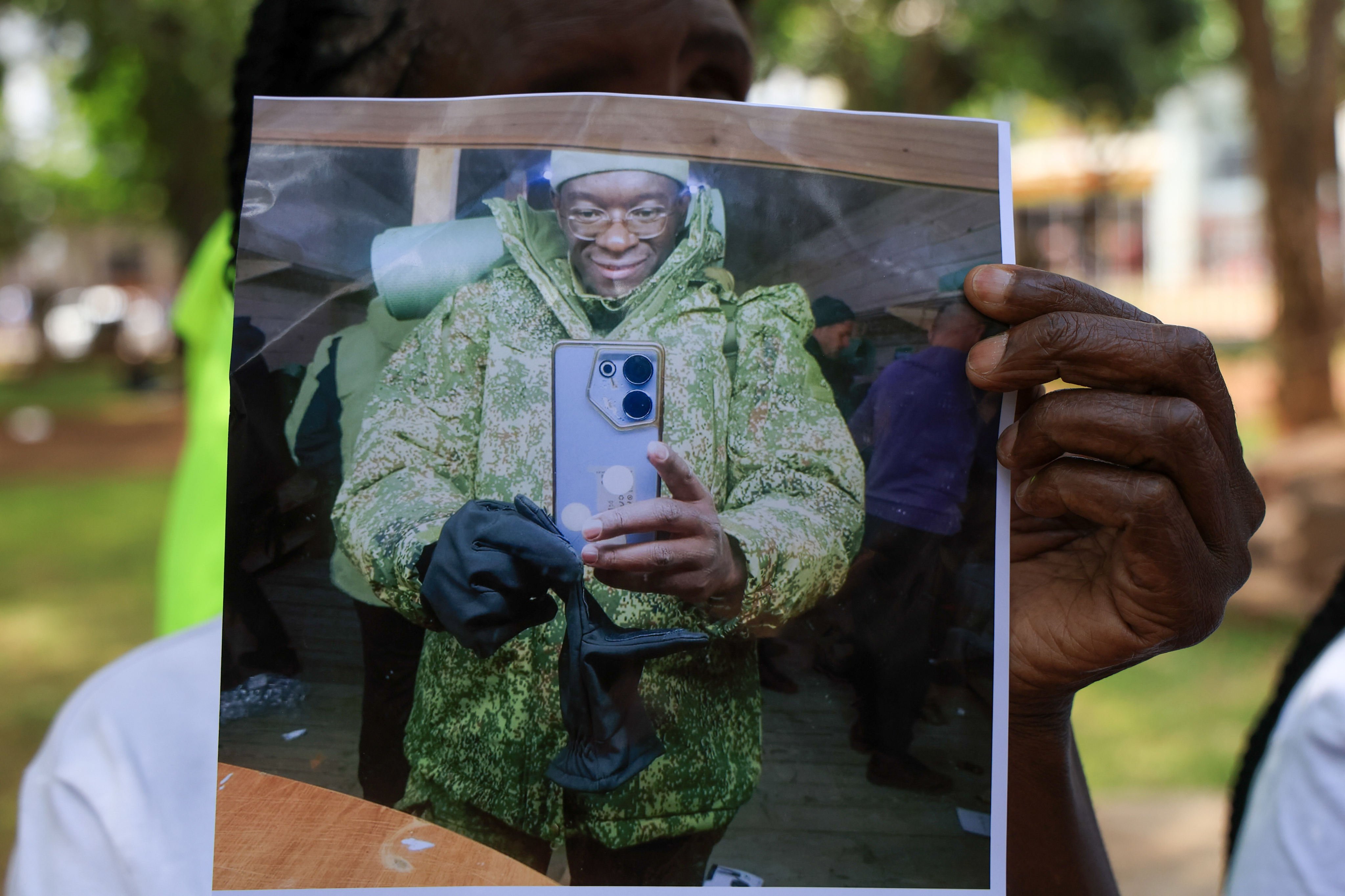 A family member holds a photo of Kenyan who joined the Russian army. Photo: AP