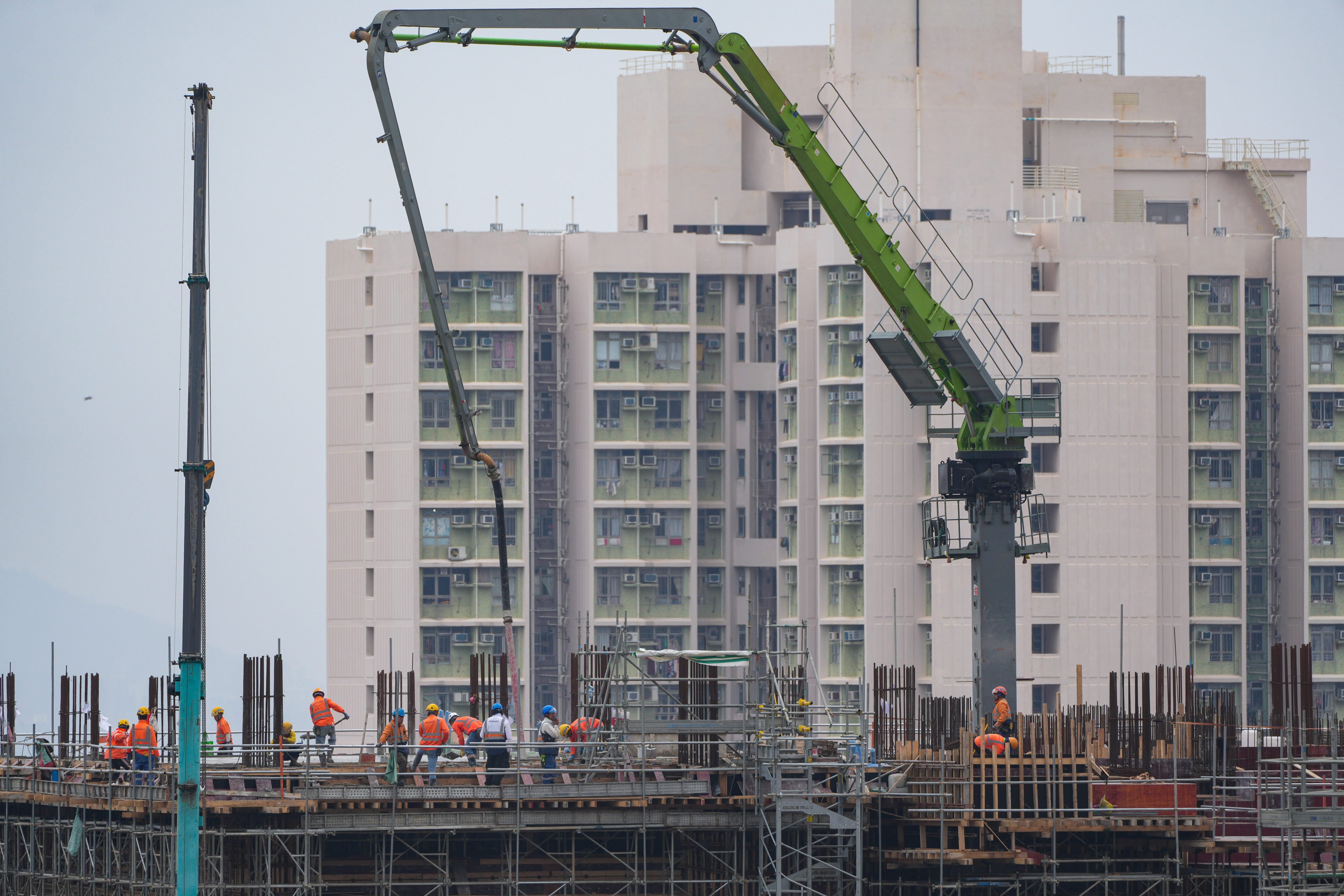 Workers at a construction site beside a public housing estate in Sau Mau Ping on February 12. Photo: Sam Tsang