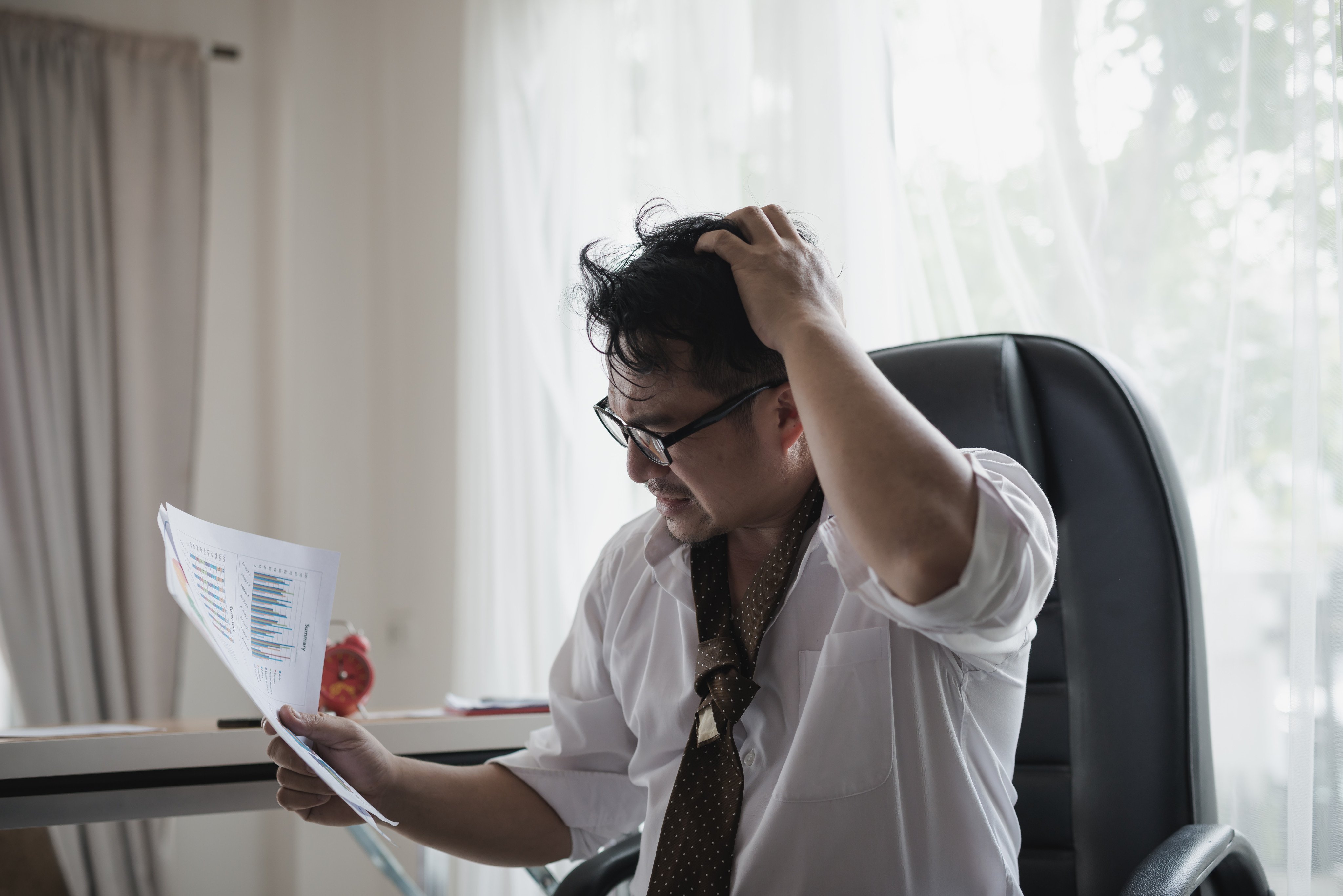 [Shutterstock] Stressed asian businessman holding his head in his hands and Data Charts,business document at office desk.
Stock Photo ID: 1049061734