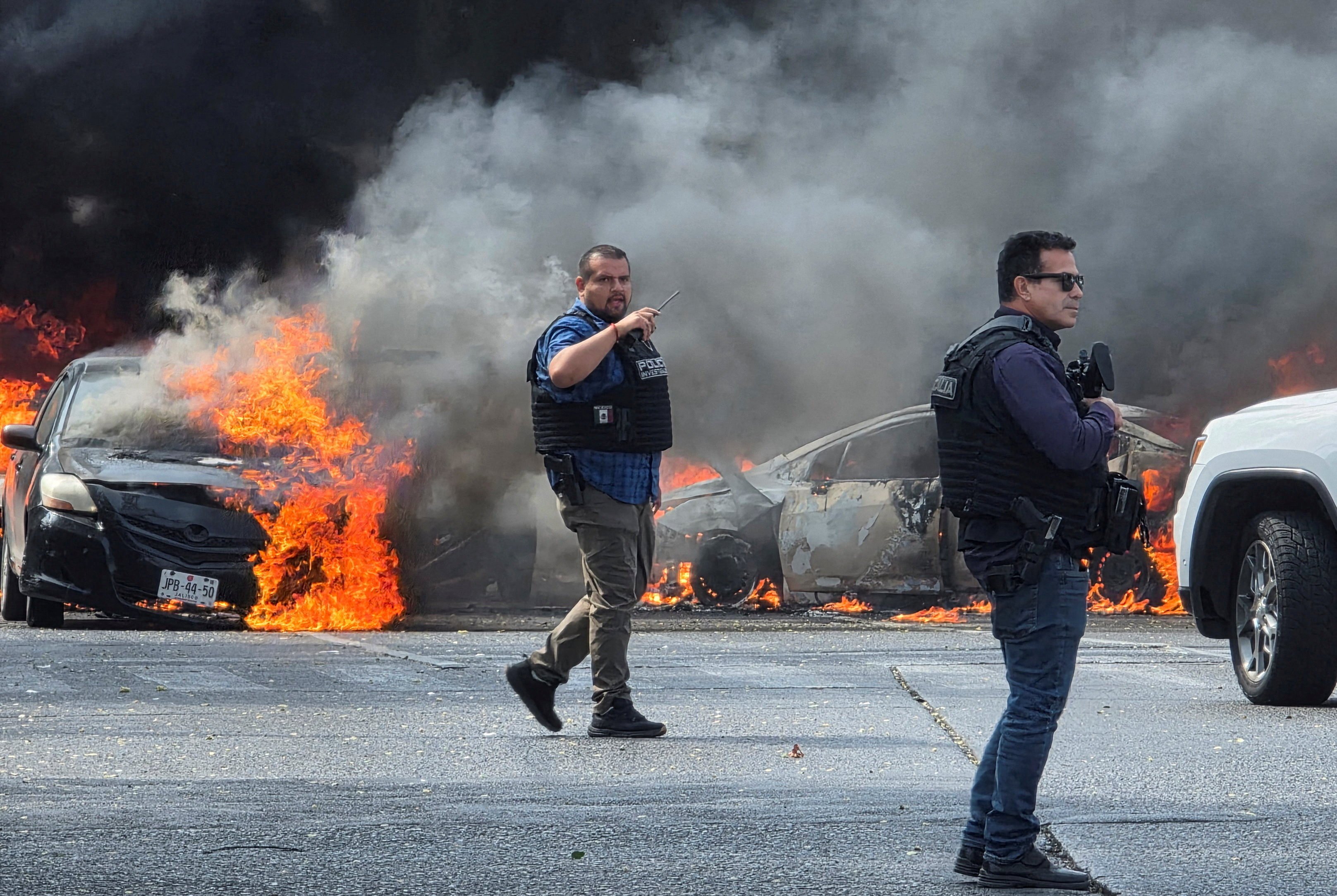 Police officers secure an area where vehicles were set on fire in Zapopan, Mexico. Photo: Reuters