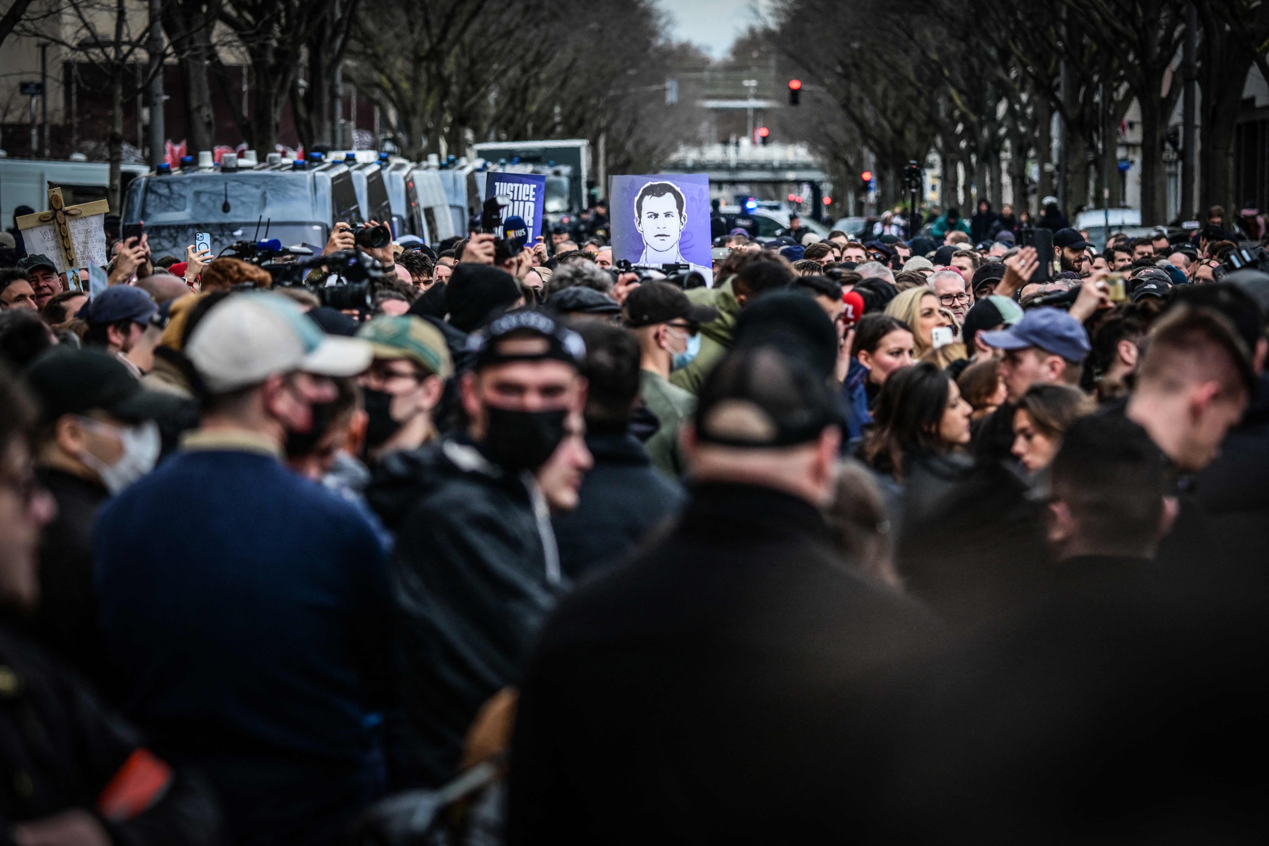 Protesters hold a portrait of far-right activist Quentin Deranque, who died after being attacked on the sidelines of a far-right protest in Lyon. Photo: AFP