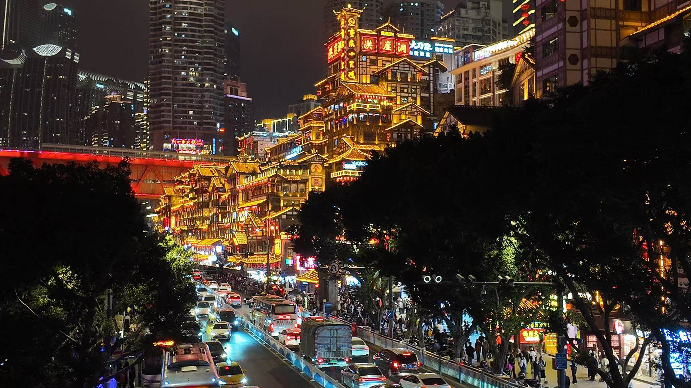 Jiefangbei Pedestrian Street in Chongqing bursts into neon splendour at night, with Hongya Cave - a sprawling “stilt building” complex that is one of the city’s most popular tourist attractions - glowing against the Chinese city’s skyscrapers. Photo: Evian Yu