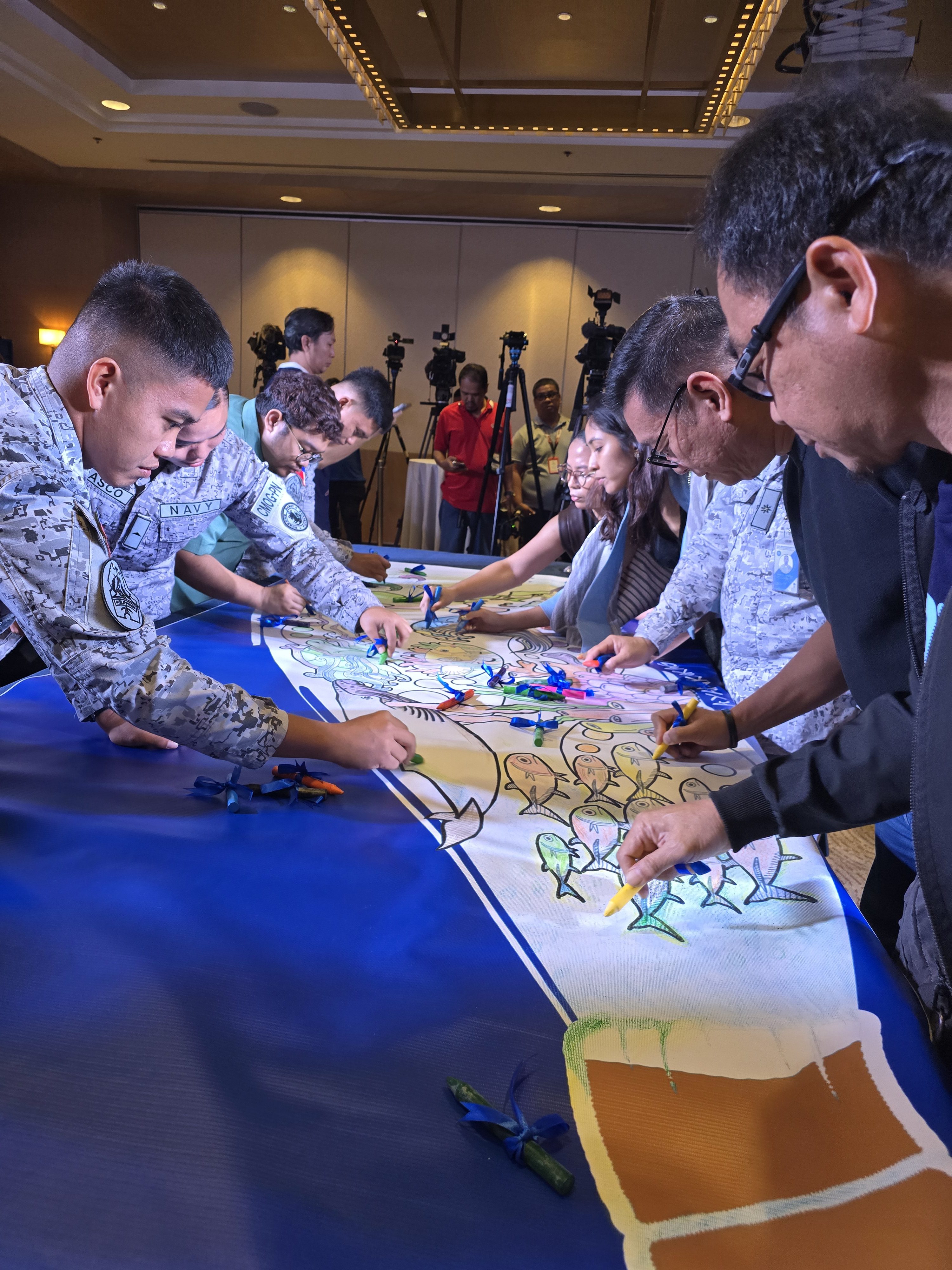Members of the Philippine Navy take part in a collaborative colouring activity during the launch of the nationwide mural contest on February 10. Photo: Raissa Robles