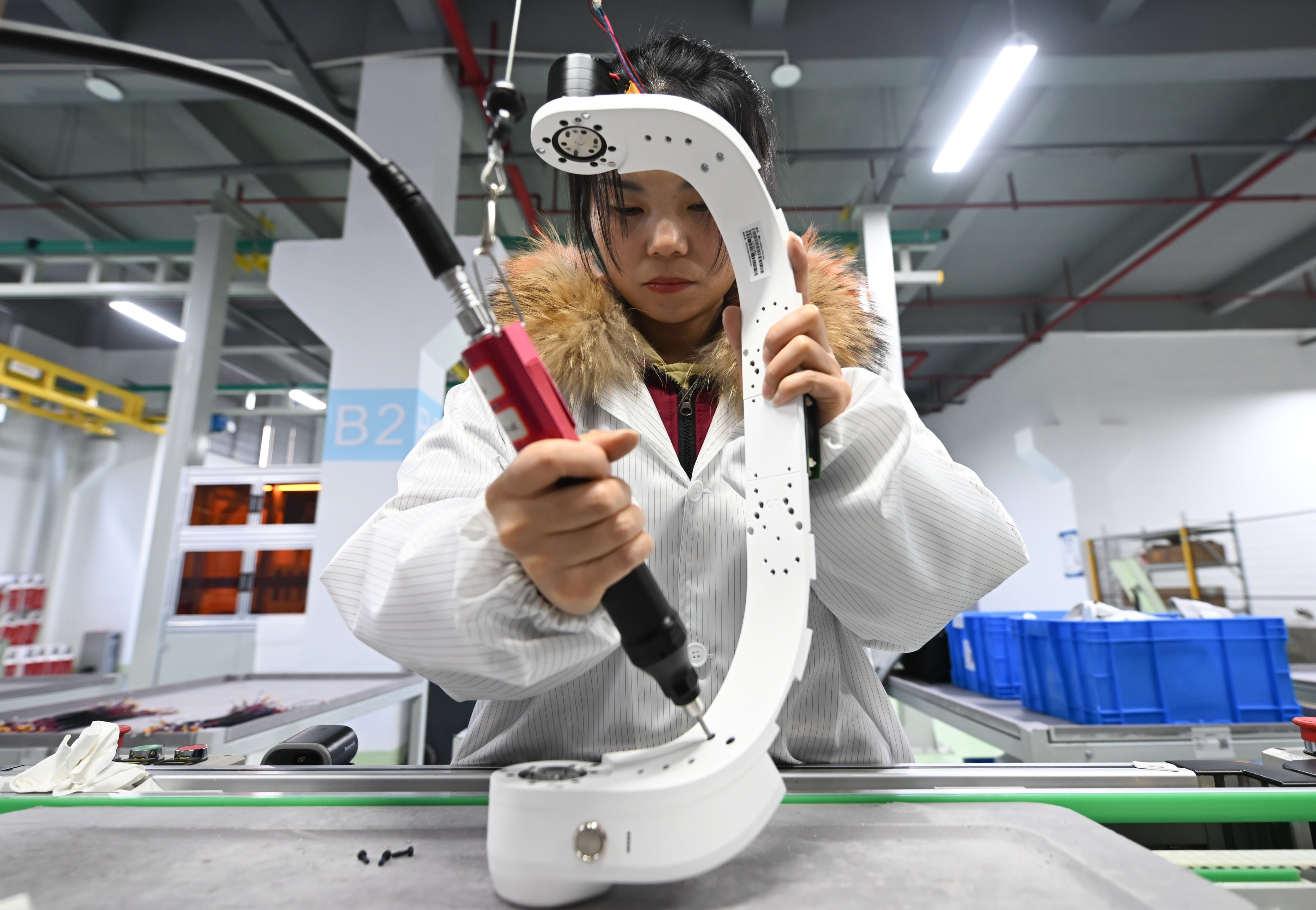 An employee works on the production line of the Tashan hip-assisted exoskeleton at a workshop in Hangzhou, capital of Zhejiang province. Photo: China News Service/VCG via Getty Images