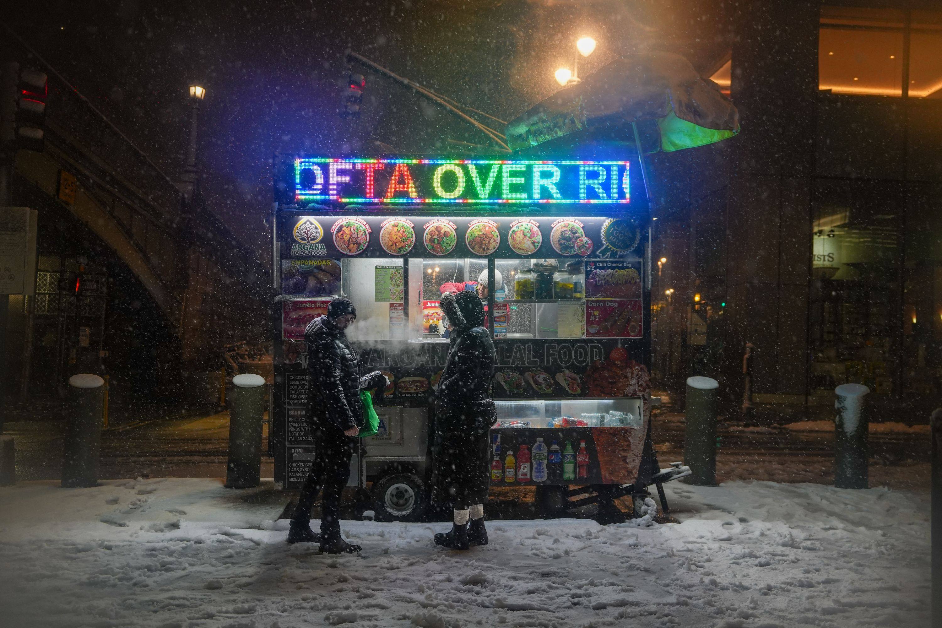 People wait for food at a halal cart after Mayor Zohran Mamdani announced a city-wide travel ban. Photo: AFP