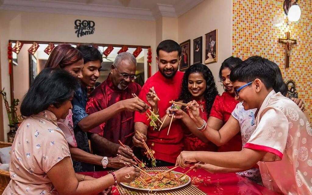 The Lourdes family take part in the traditional “yusheng” toss on Lunar New Year’s Eve. Photo: Alyssa Ann Lourdes