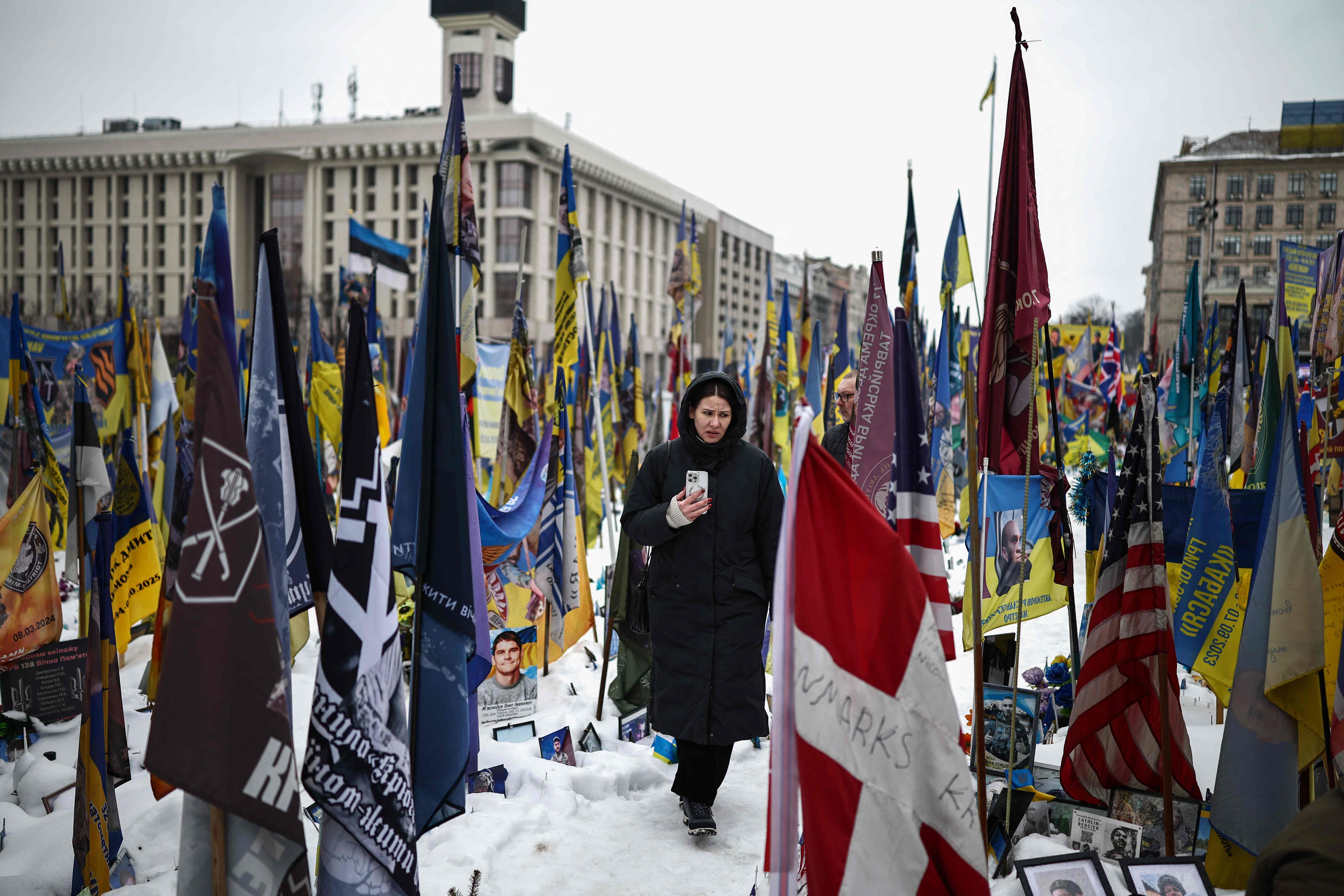 A person walks through a makeshift memorial to fallen soldiers in Kyiv, Ukraine on Monday, as the conflict with Russia reaches its four-year mark. Photo: AFP