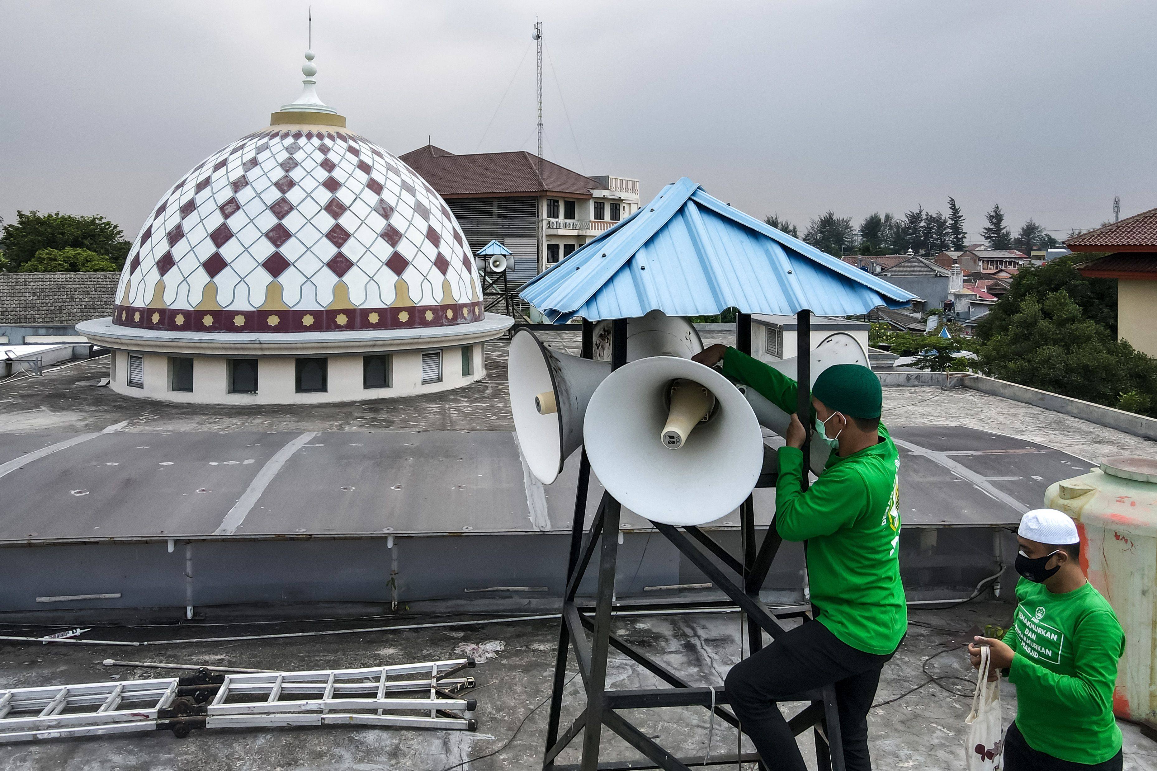Officials inspecting a mosque’s speakers in Jakarta. Photo: AFP