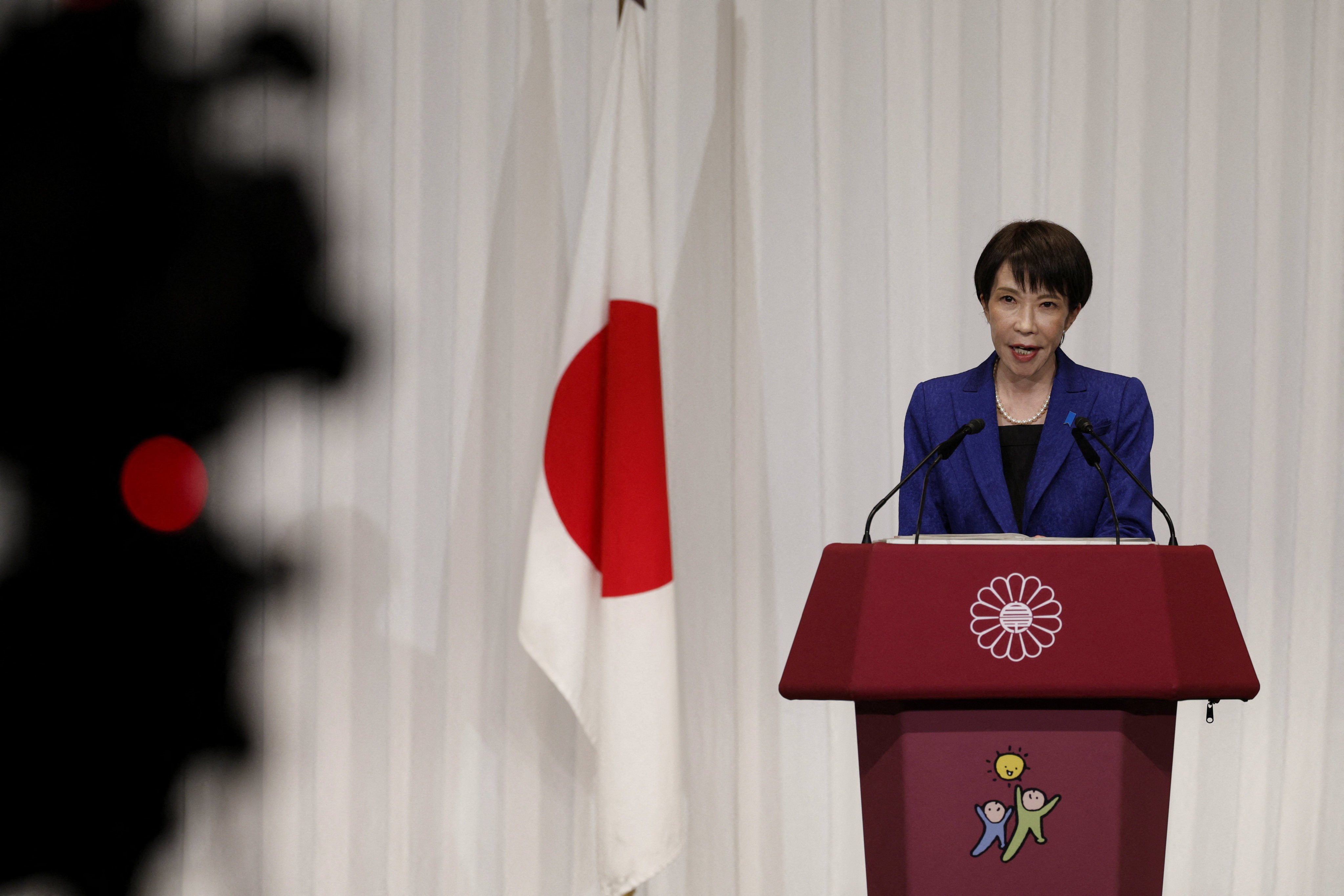 Japan’s Prime Minister Sanae Takaichi speaks next to a Japanese national flag during a press conference at the LDP headquarters in Tokyo on February 9. Photo: Reuters