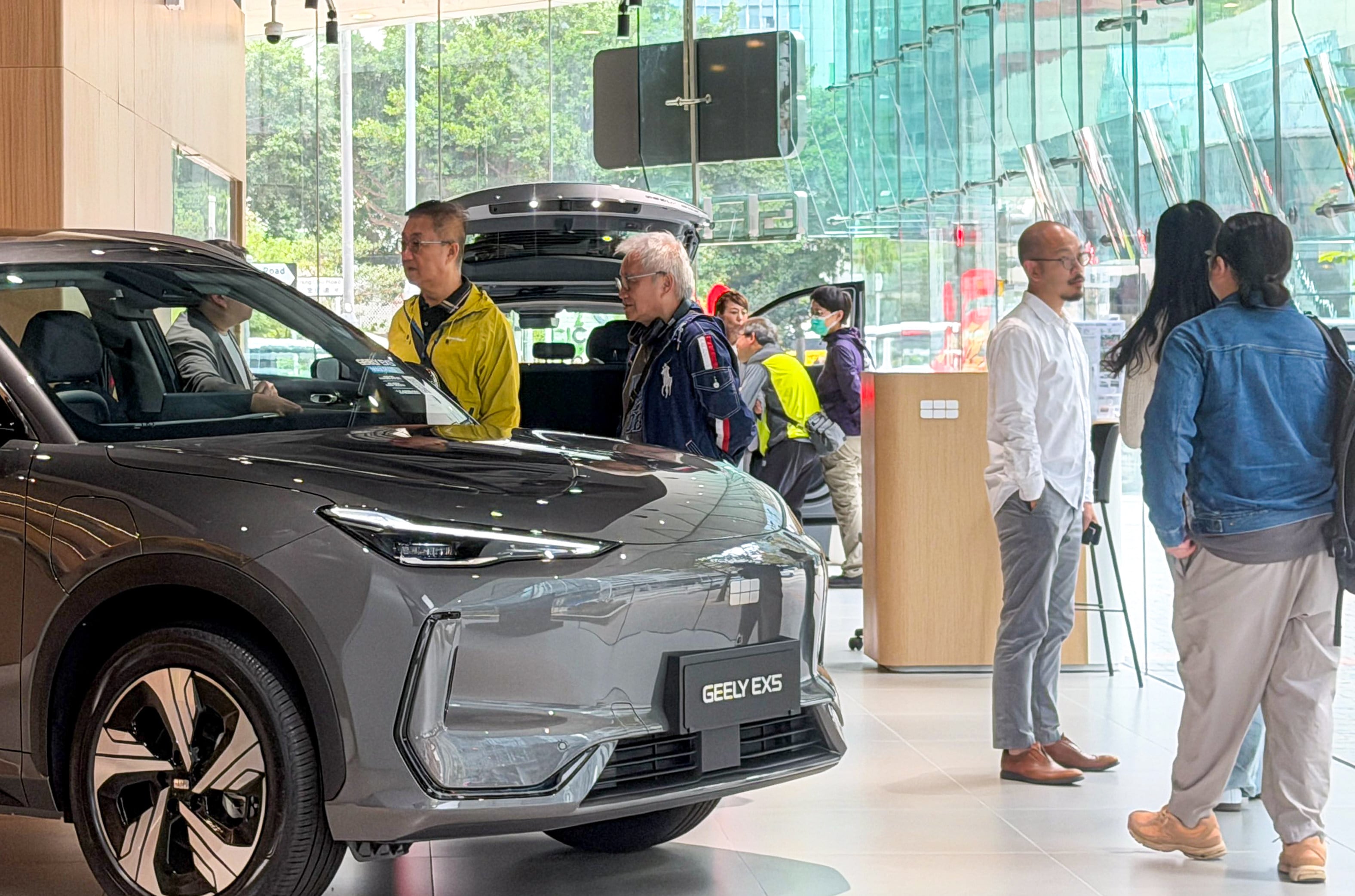 Customers at a Geely electric vehicle showroom in Kowloon Bay. Photo: Jelly Tse