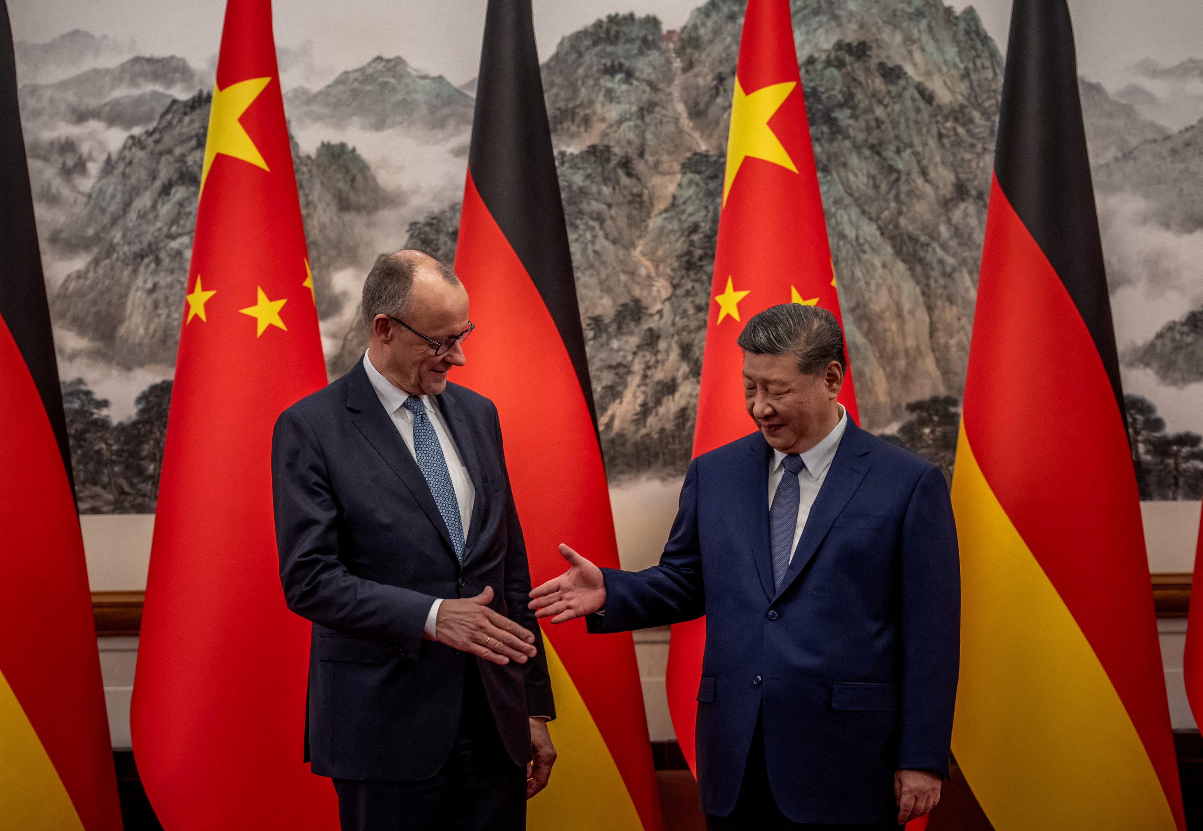 German Chancellor Friedrich Merz, left, shakes hands with President Xi Jinping at the state guesthouse in Beijing on February 25. Photo: Reuters