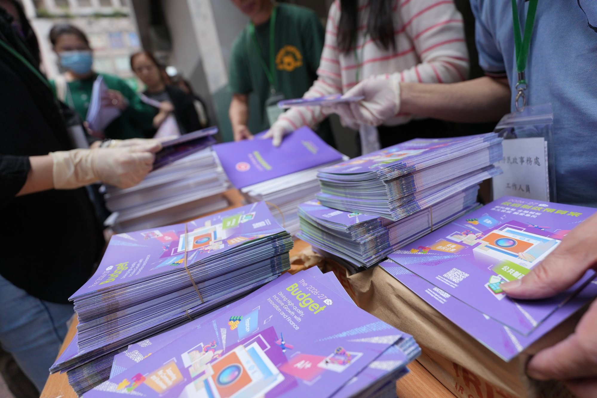 People collect booklets and leaflets of the budget outside Wan Chai District Office. Photo: Karma Lo