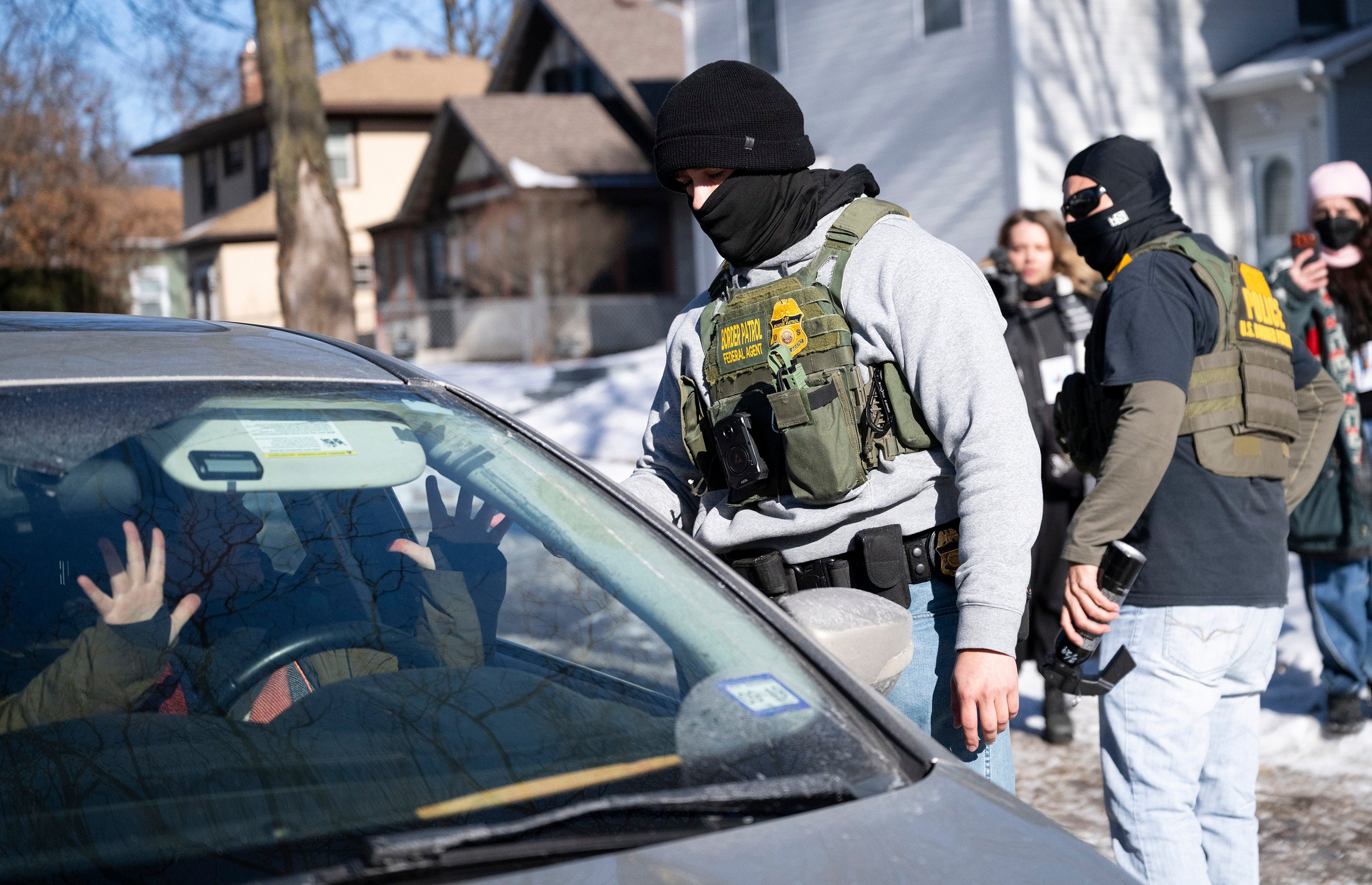A member of the US Border Patrol confronts the driver of a car n Minneapolis on January 29. Photo: Getty Images/TNS