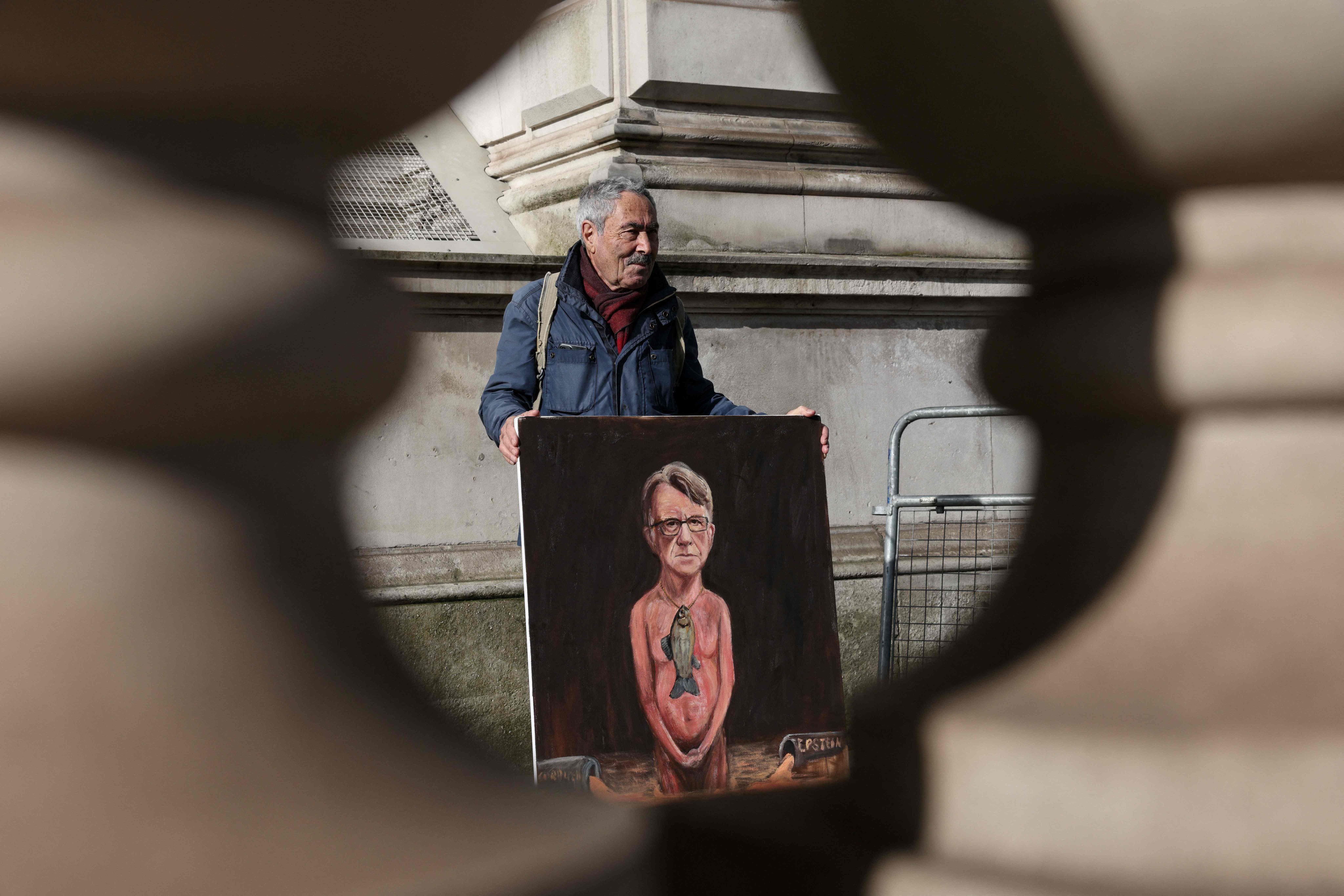 Artist Kaya Mar displays a painting of Britain’s former ambassador to the US, Peter Mandelson, outside Downing Street in central London on Wednesday. Photo: AFP