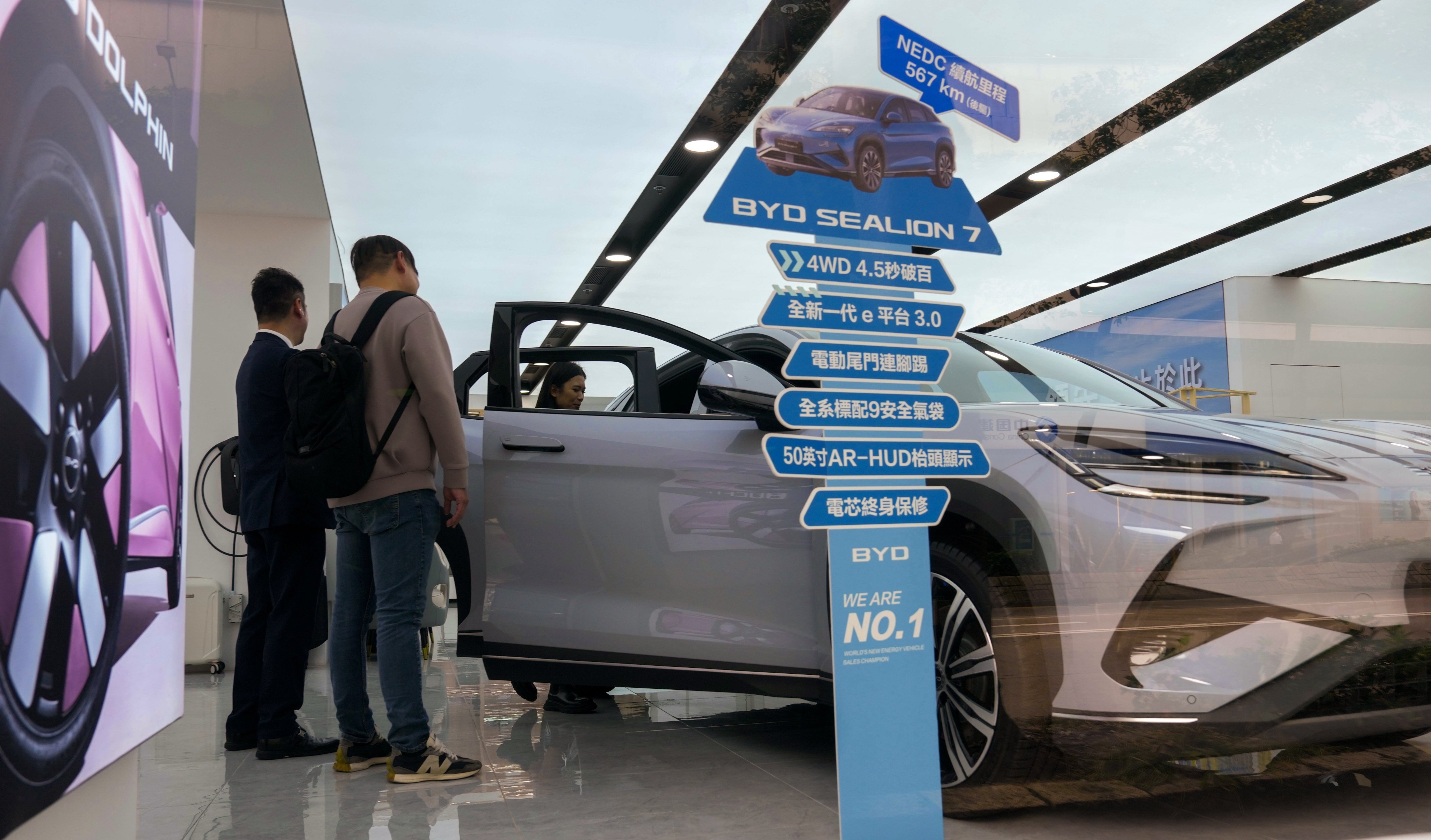 People shop for electric vehicles at a store in Wan Chai on February 26, after the financial secretary said subsidies for private EVs would not be renewed. Photo: Jelly Tse