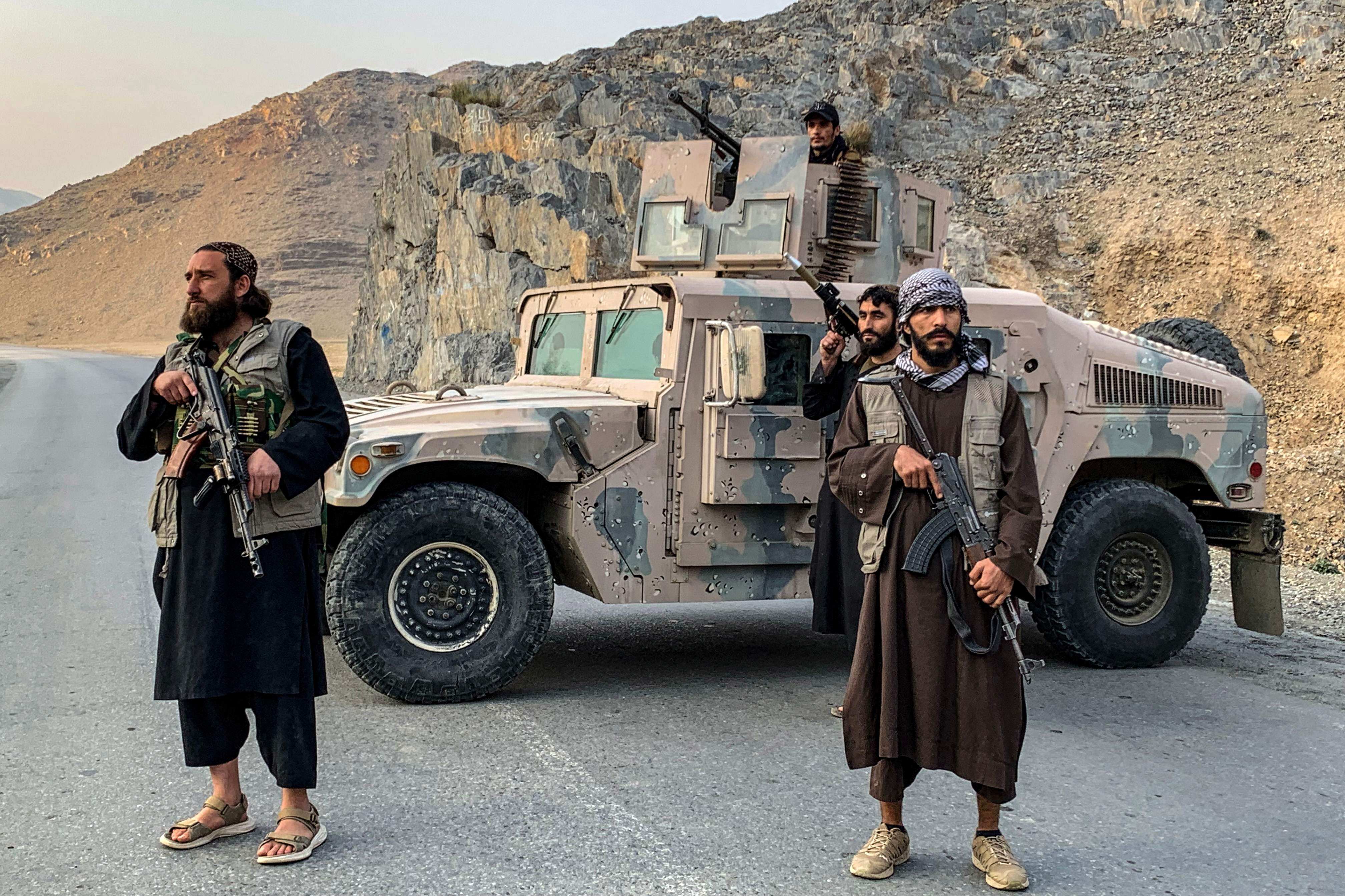 Taliban security personnel stand guard near the Torkham border crossing between Afghanistan and Pakistan on Friday. Photo: AFP