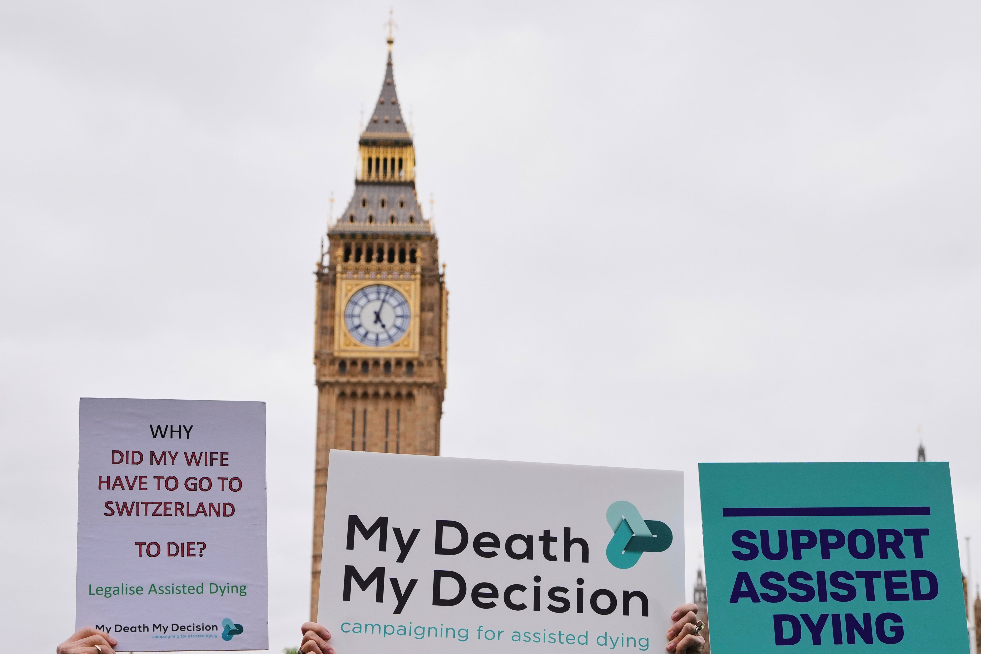 Pro-assisted dying campaigners holding banners in London last year. Photo: AP