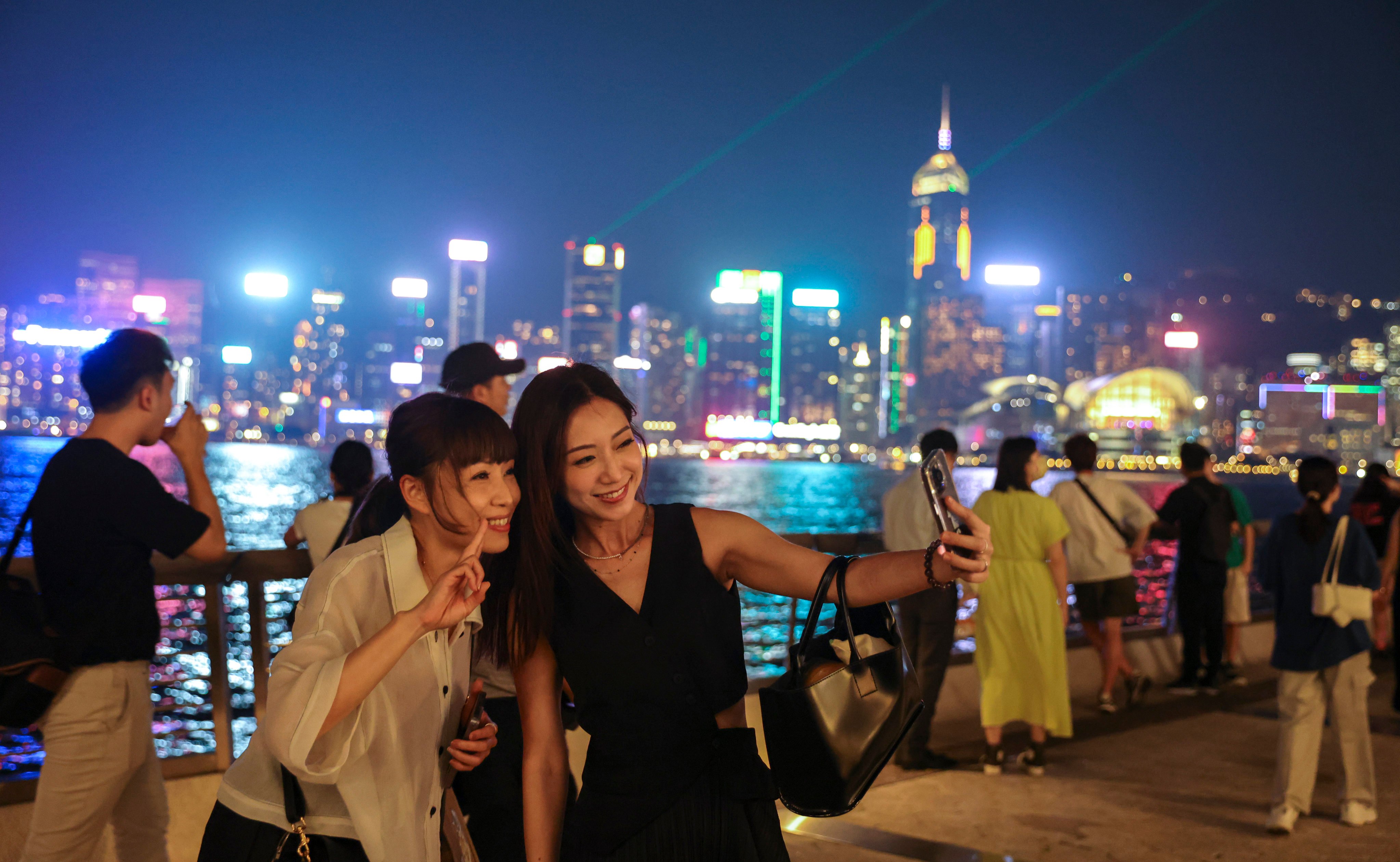 Tourists enjoy “A Symphony of Lights” at Tsim Sha Tsui’s Avenue of Stars. Photo: Yik Yeung-man