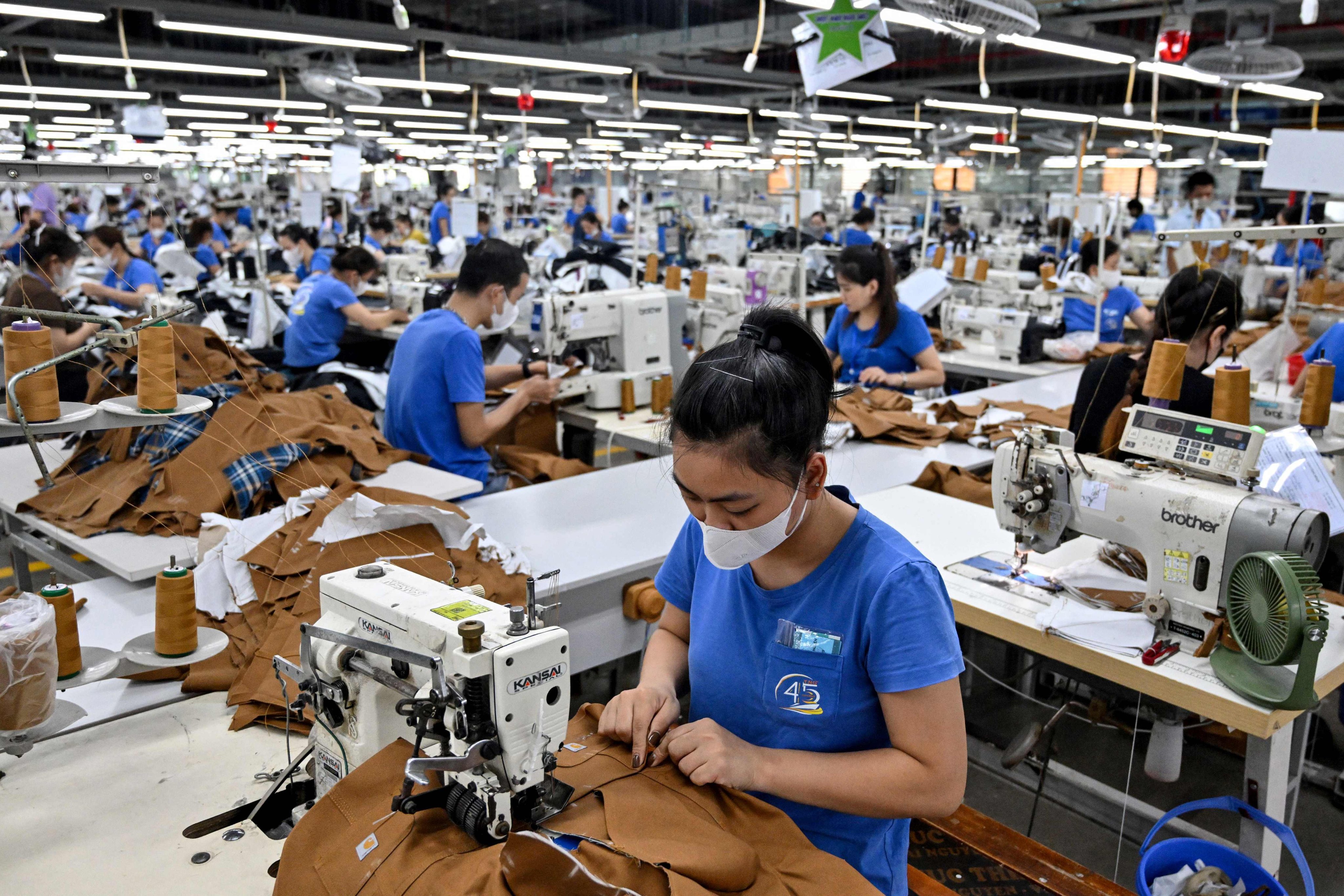 Vietnamese workers stitch apparel at a garment factory in Thai Nguyen province on July 2, 2025. Photo: AFP